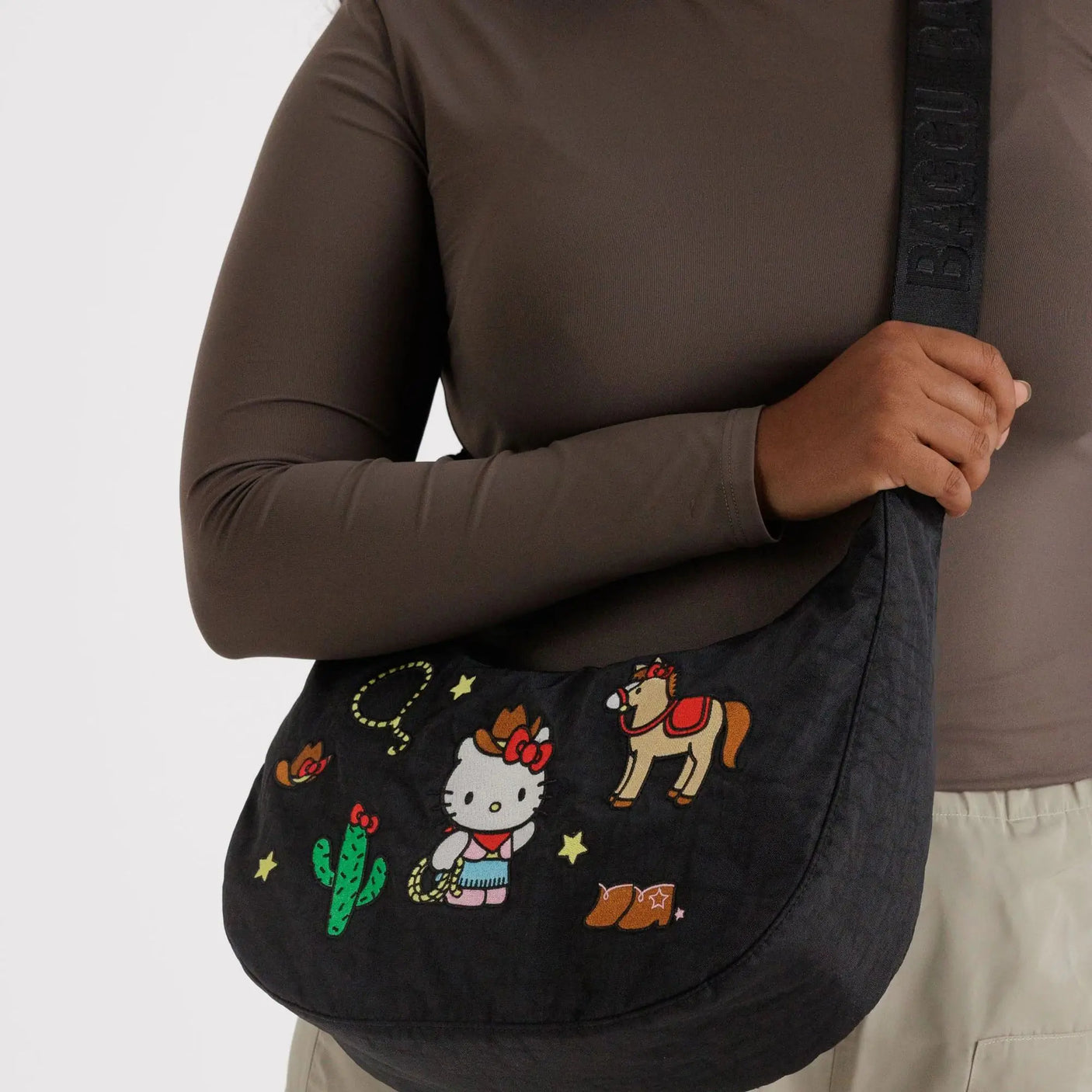 Black medium crescent shoulder bag in nylon with cowboy-themed Hello Kitty print