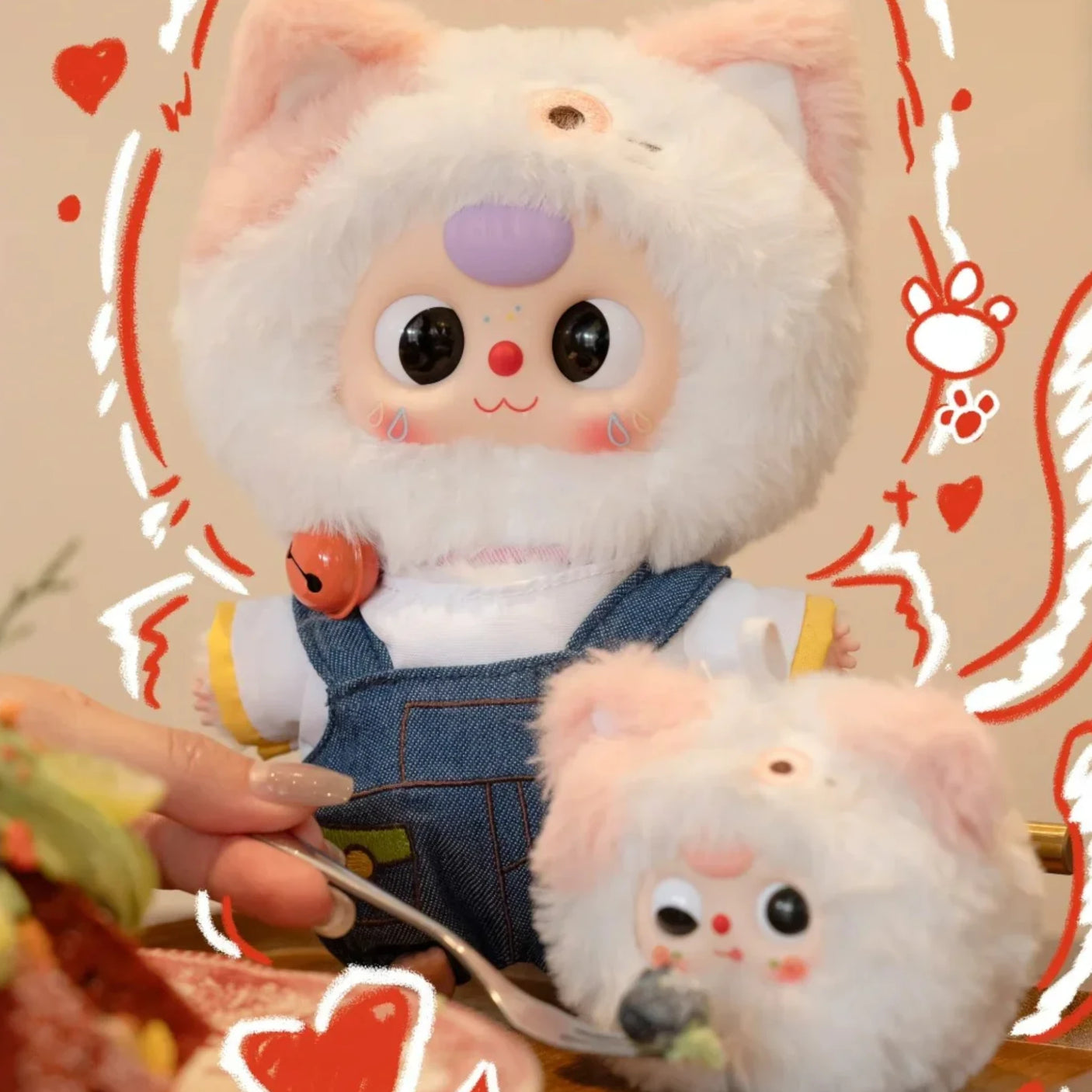 Two plush animal keychains: white cat in pink hoodie and small white mouse in denim; ring