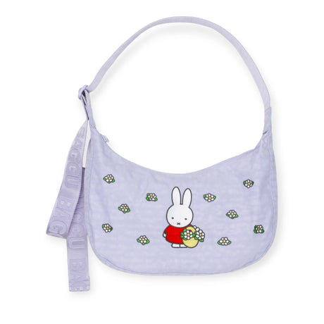The Miffy x Baggu Medium Nylon Crescent is a lavender crossbody bag with a cartoon bunny and floral details, an adjustable "BAGGU" strap, and recycled nylon—making this playful Baggu accessory perfect for everyday use.
