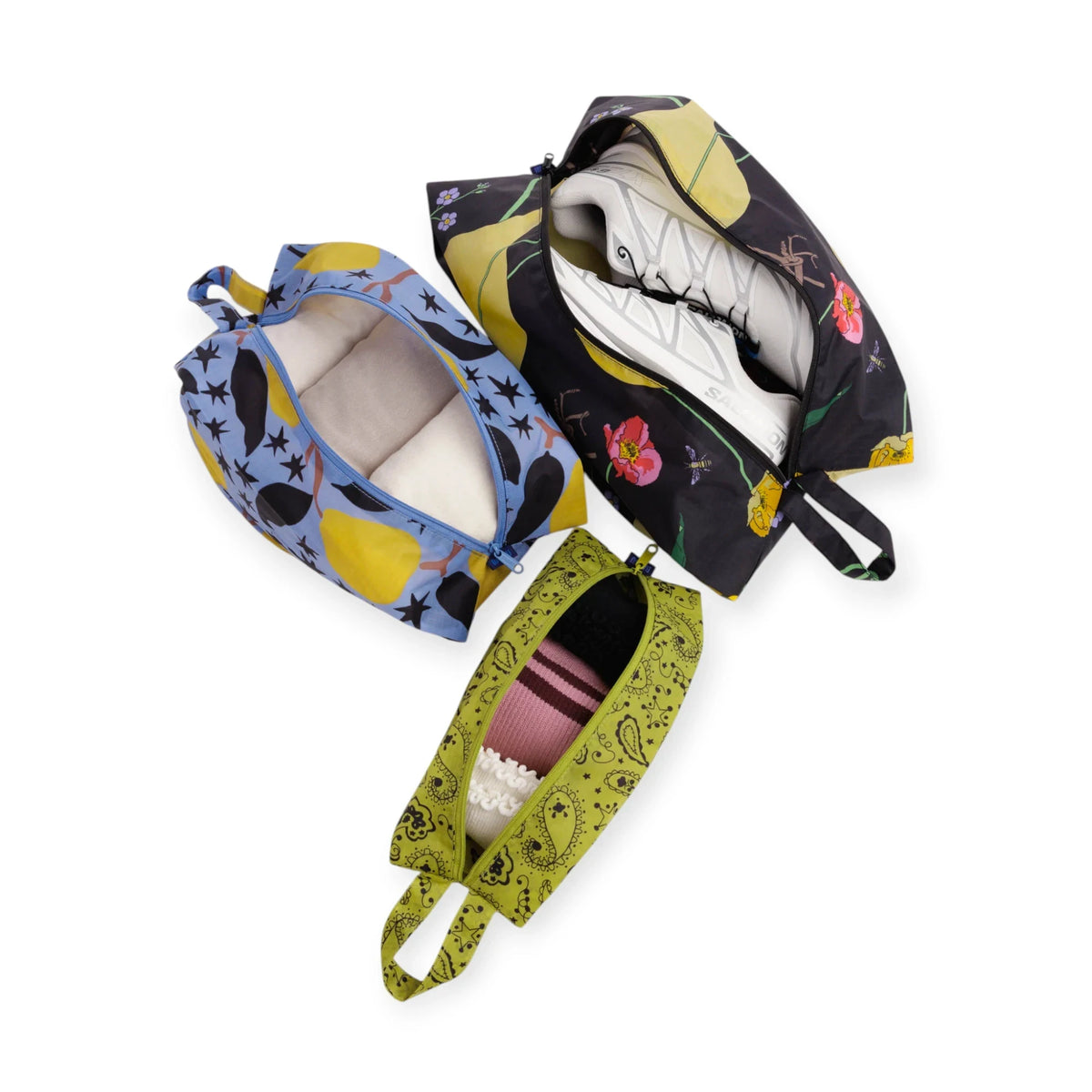 Baggu 3D storage travel set of three patterned pouches, one opened to show contents