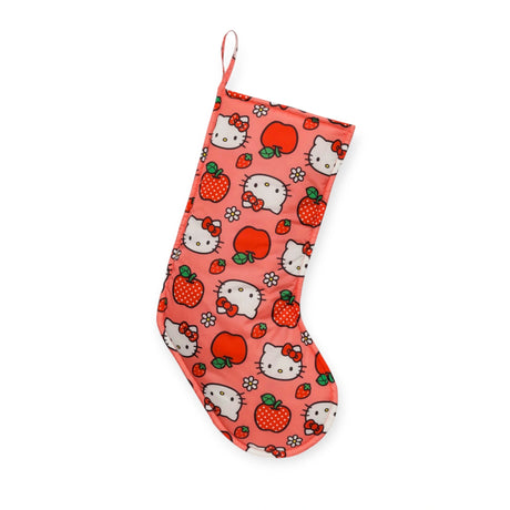 The Hello Kitty x Baggu Christmas Stocking by Baggu is a charming piece featuring cartoon cat faces, apples, and strawberries set against a pink background, crafted from durable recycled ripstop nylon.