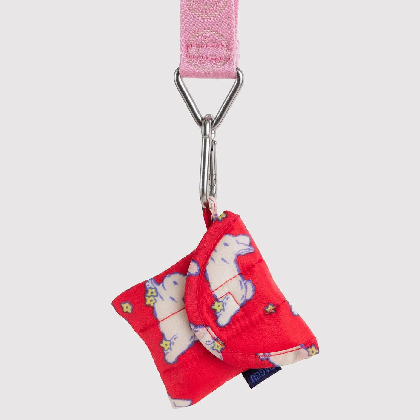 Pink keychain strap with silver clip, holding red fabric bow charm