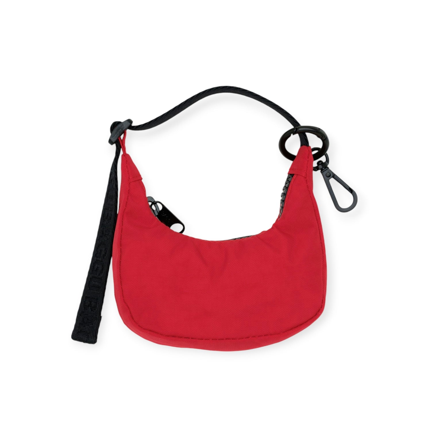The Baggu Crescent Bag Charm in Cornflower is a blue crescent-shaped shoulder bag made from recycled nylon, with a detachable black strap and a sleek metal clasp.