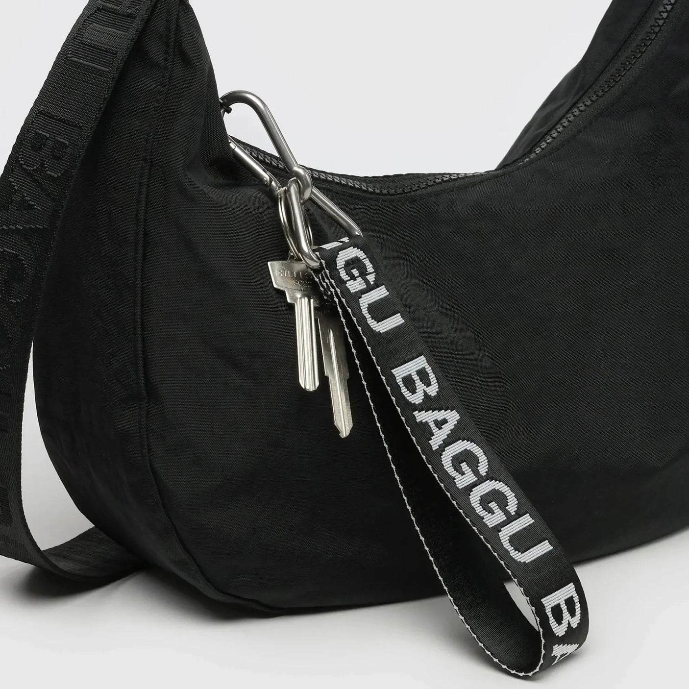 Black Baggu logo keychain strap with metal clip and dangling keys