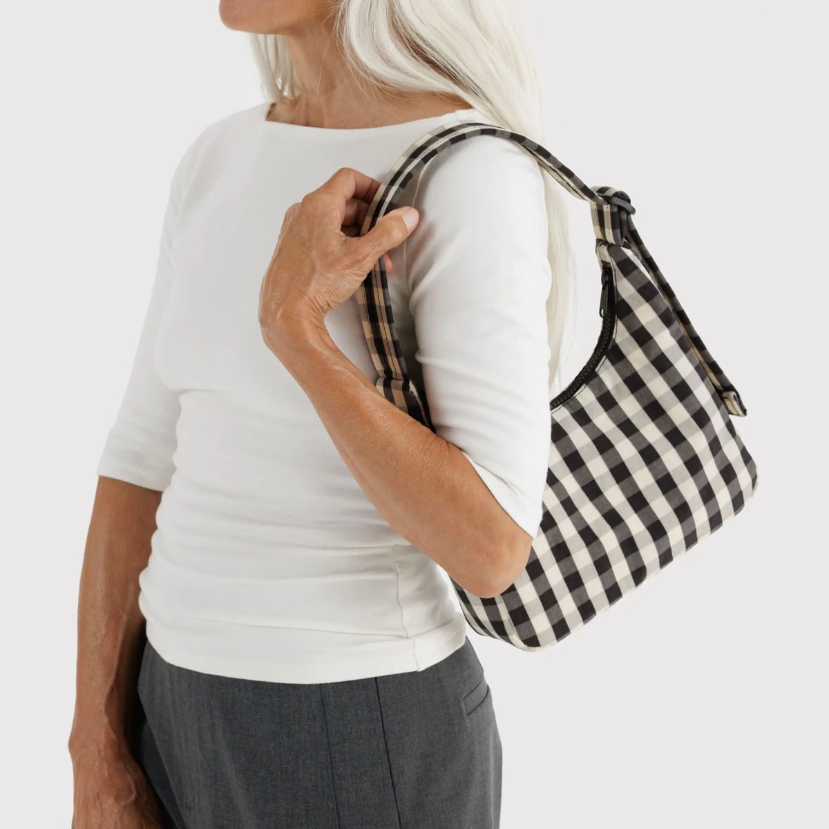 Black-and-cream gingham mini shoulder bag, carried on shoulder with strap