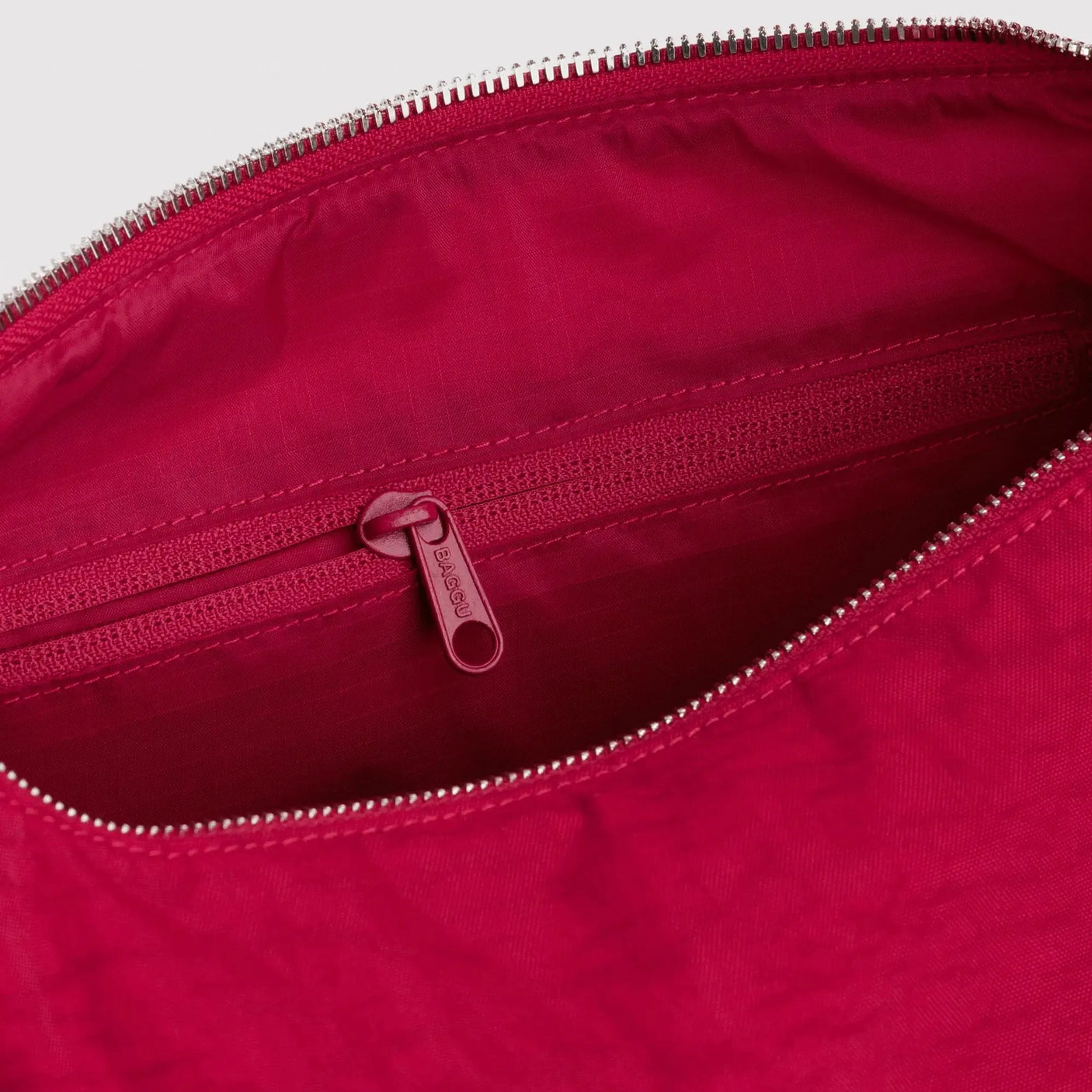 Cherry red nylon tote bag interior with zippered opening and smooth lining
