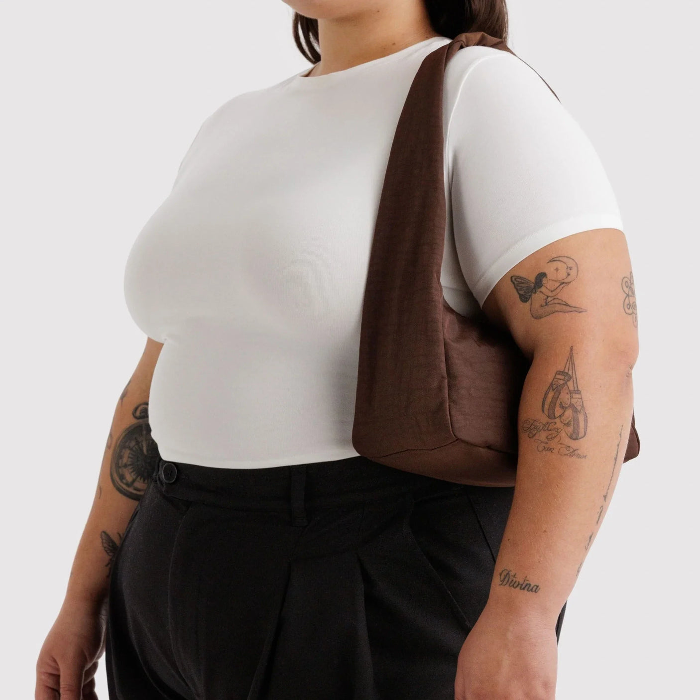 Small coffee-brown nylon hobo bag worn over shoulder