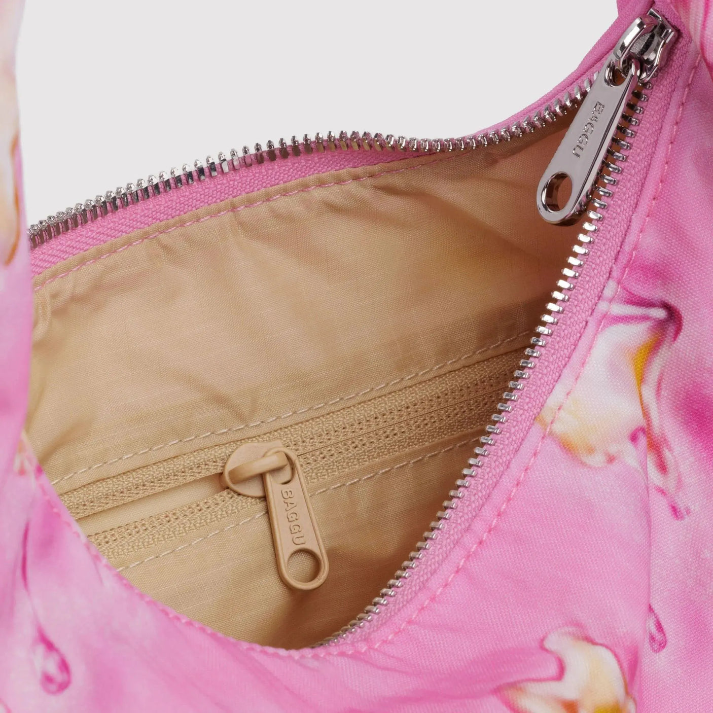 Pink small nylon hobo bag with tan lining and zippered opening