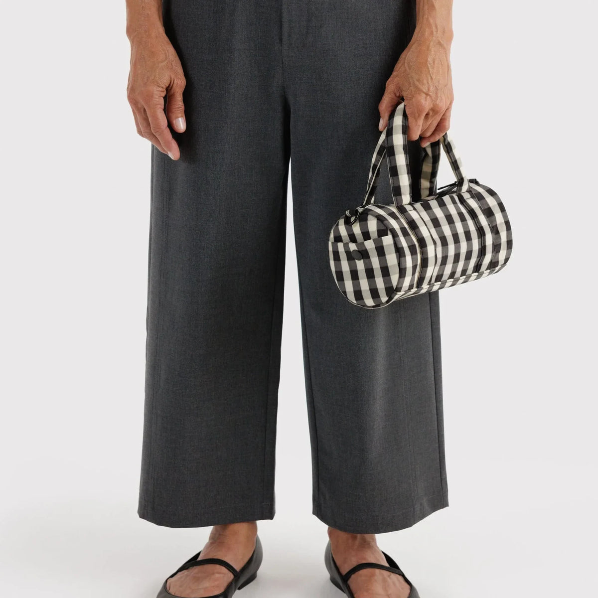 Small nylon duffle bag in black-and-cream gingham with top handle