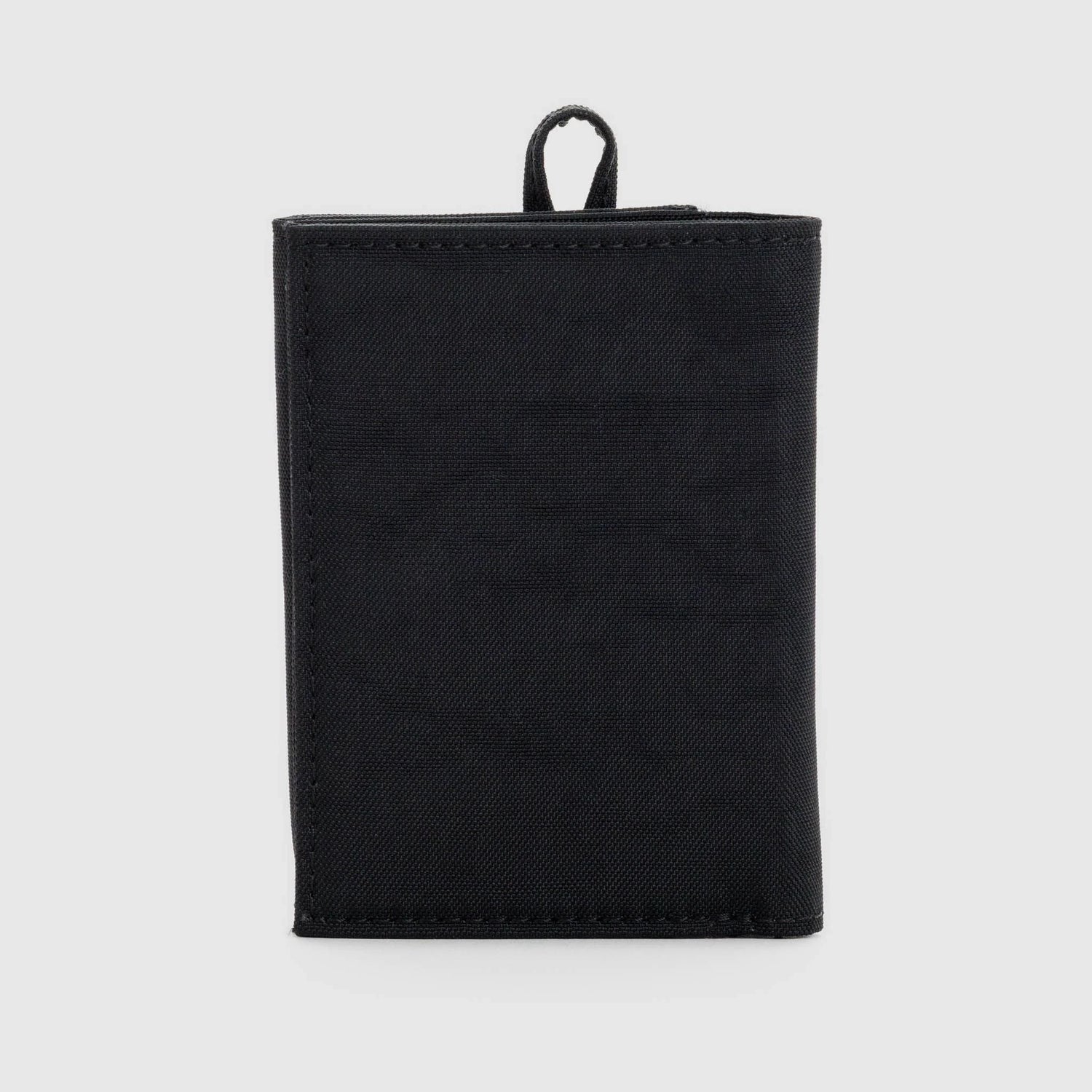 The Baggu Snap Wallet - Black from Baggu is a minimalist closed black fabric design with a small loop handle on top. It stands upright against a plain gray background, merging style and functionality seamlessly.