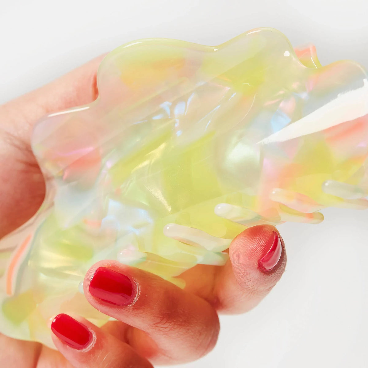 Close-up translucent sherbet jelly claw clip with pastel yellow, pink, and blue highlights