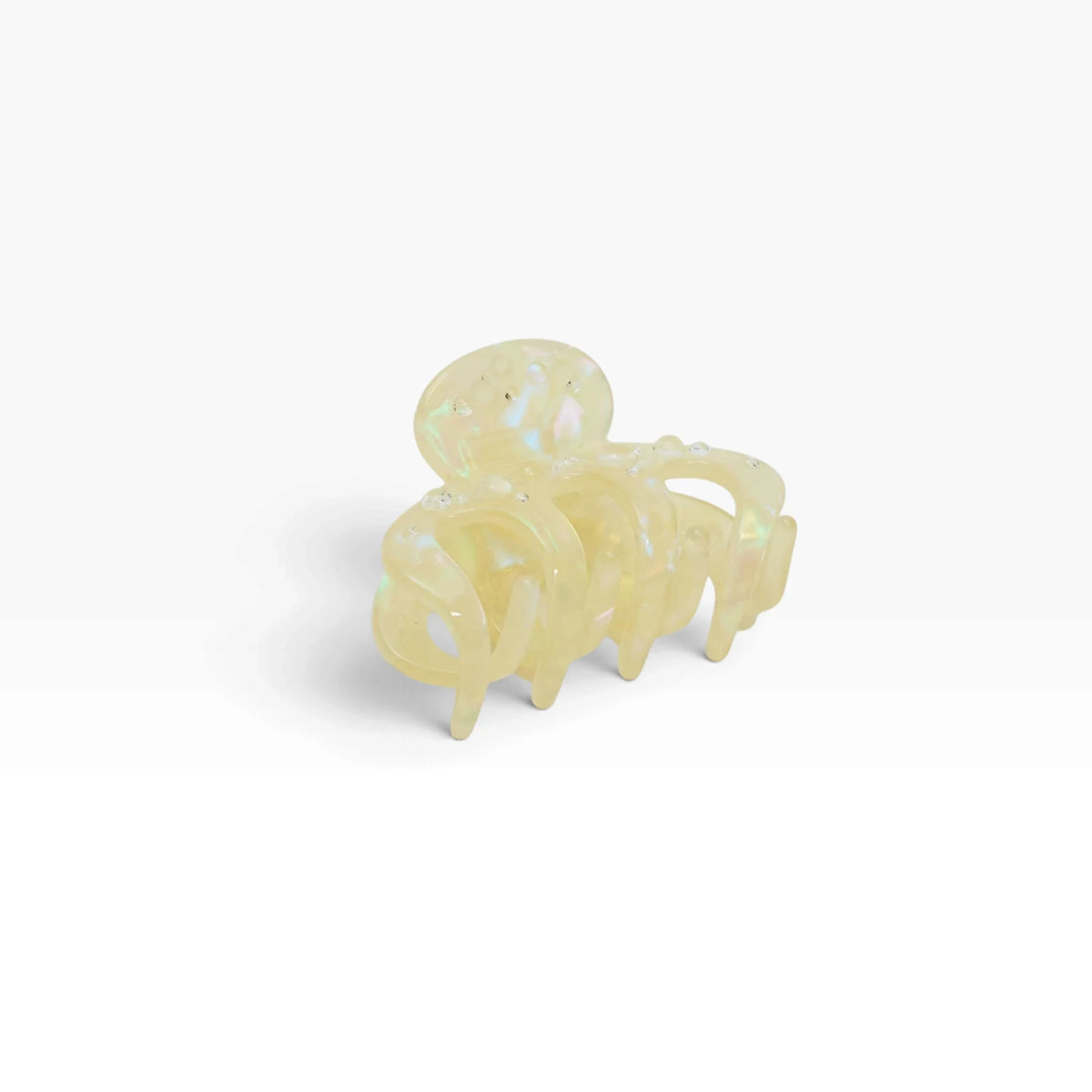 Small octopus claw hair clip, pearl-shimmer translucent cream, shell-like claws.