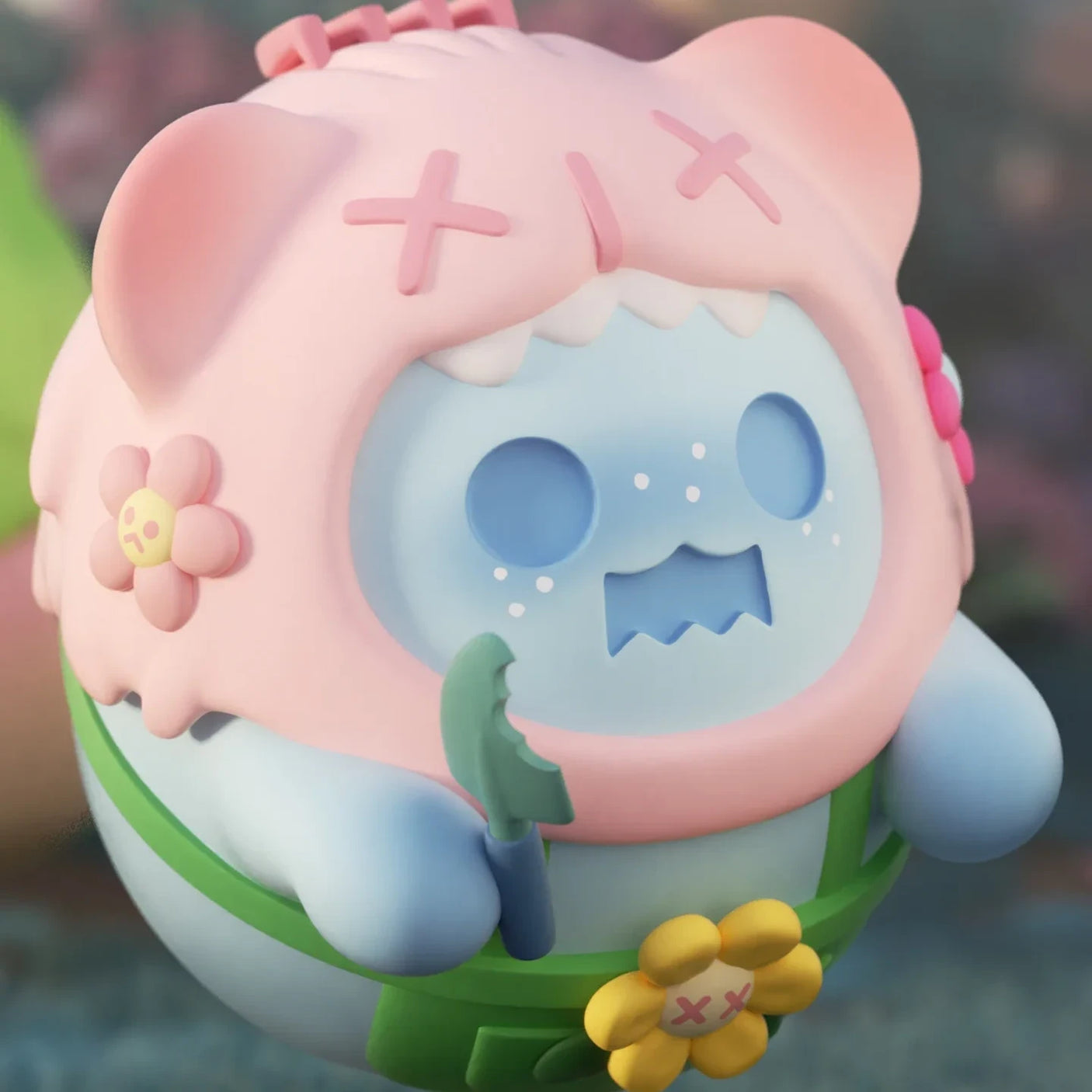 Blue ShinWoo Secret Bear figure wearing pink hood with crossed eyes and holding green accessory in soft outdoor setting