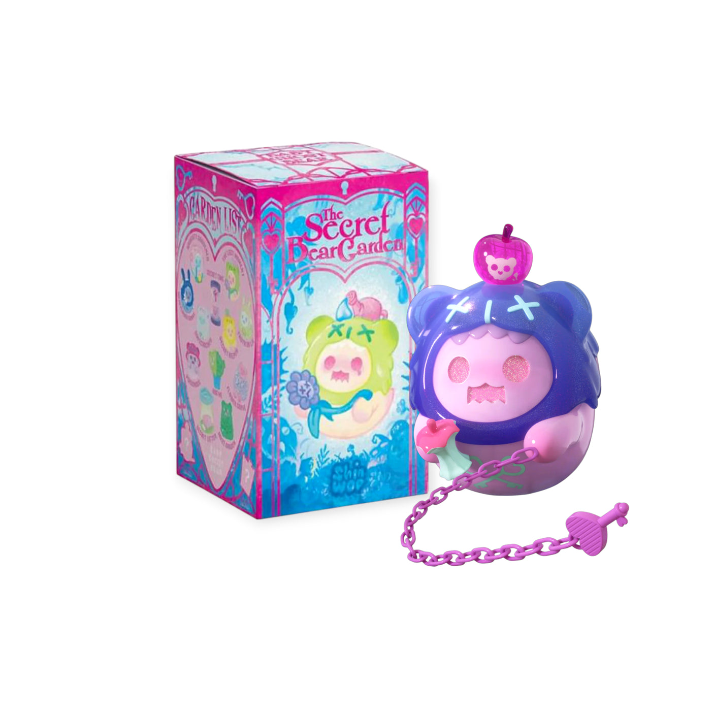 Purple and pink ShinWoo Secret Bear figure with apple hat and chain accessory next to colorful Secret Bear Garden blind box packaging