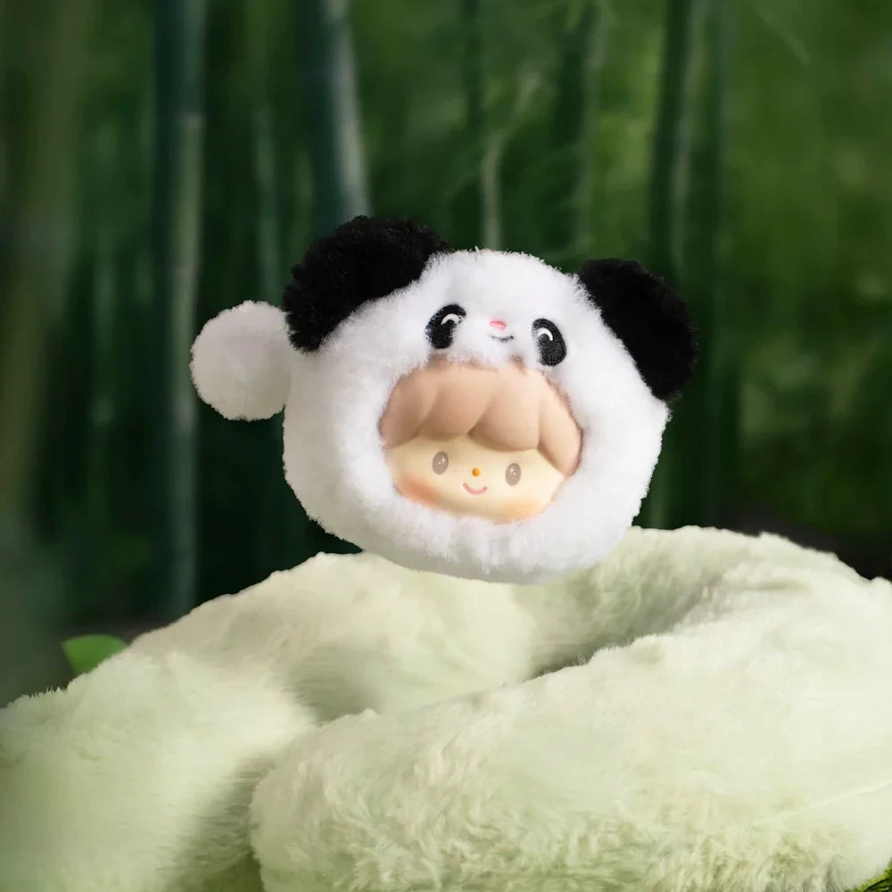 Round plush pouch with a smiling character inside a panda hood in a soft forest setting background