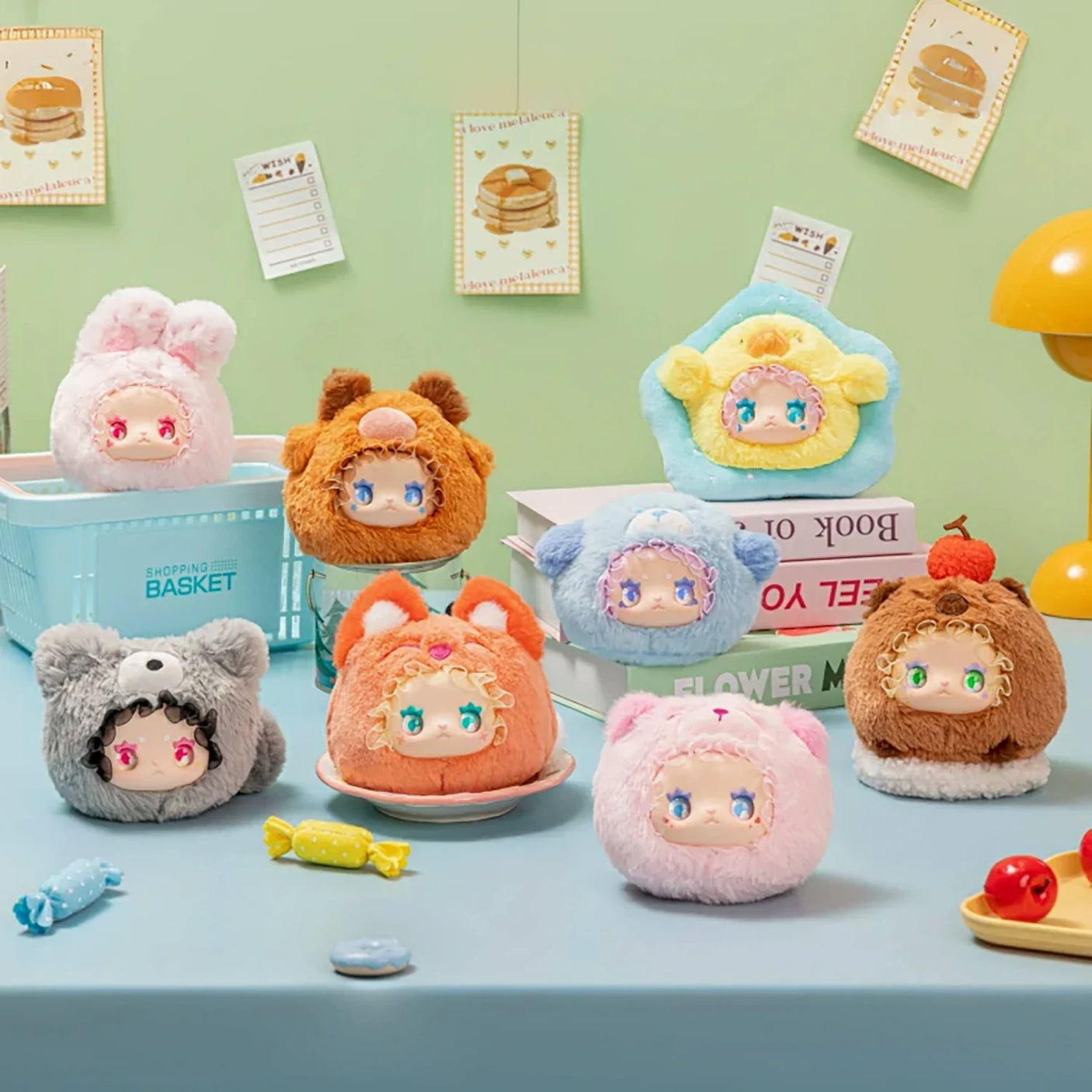 Eight Lovely Emma Rua Rua Zoo plush bag charms dressed as various cute animals displayed on pastel table with books and candies