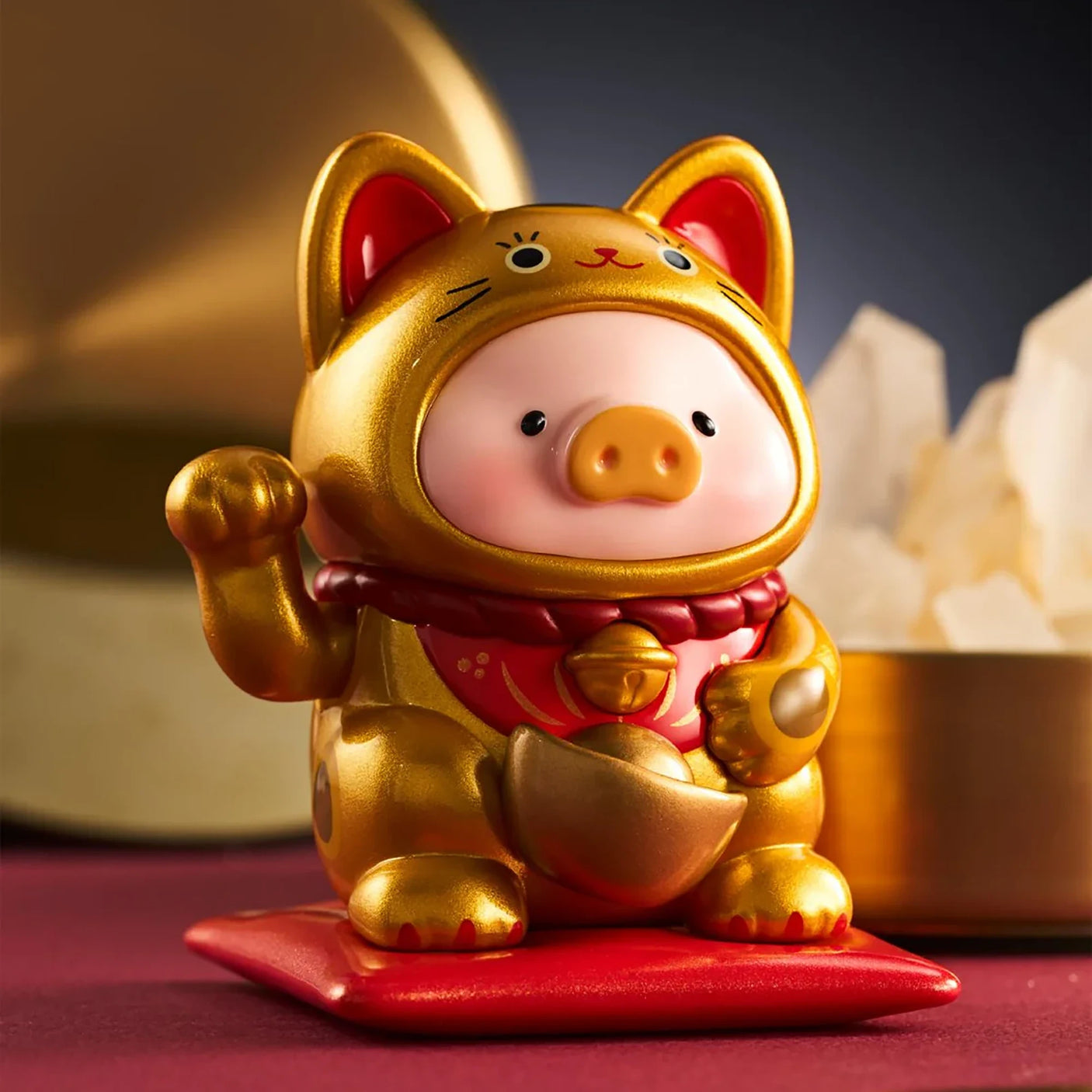 LuLu The Piggy - Lucky Cat Blind Box featuring a piggy figurine in a shiny gold lucky cat costume on a red cushion by LuLu The Piggy