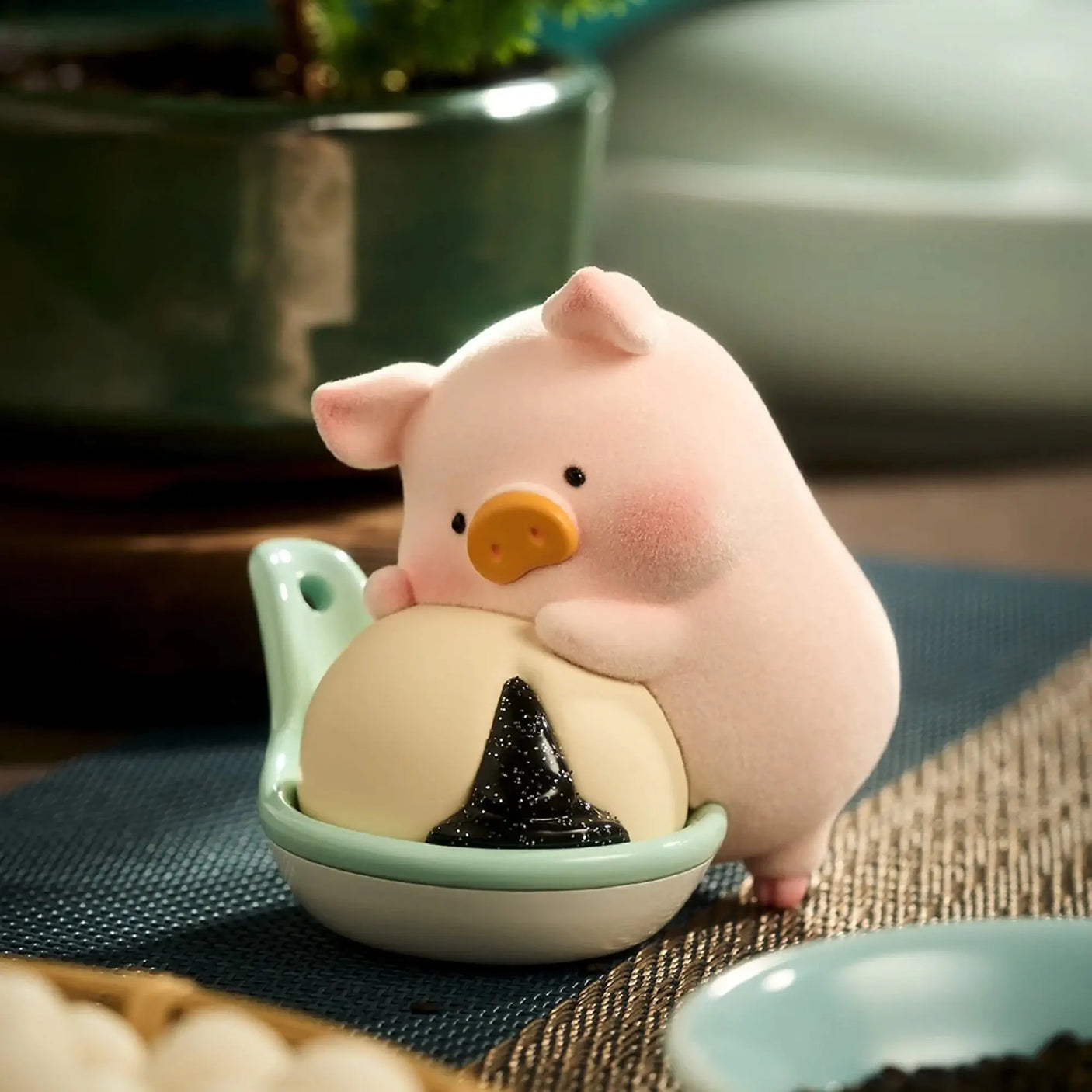 Pig chef figurine next to a small bowl with a dark tree-shaped food
