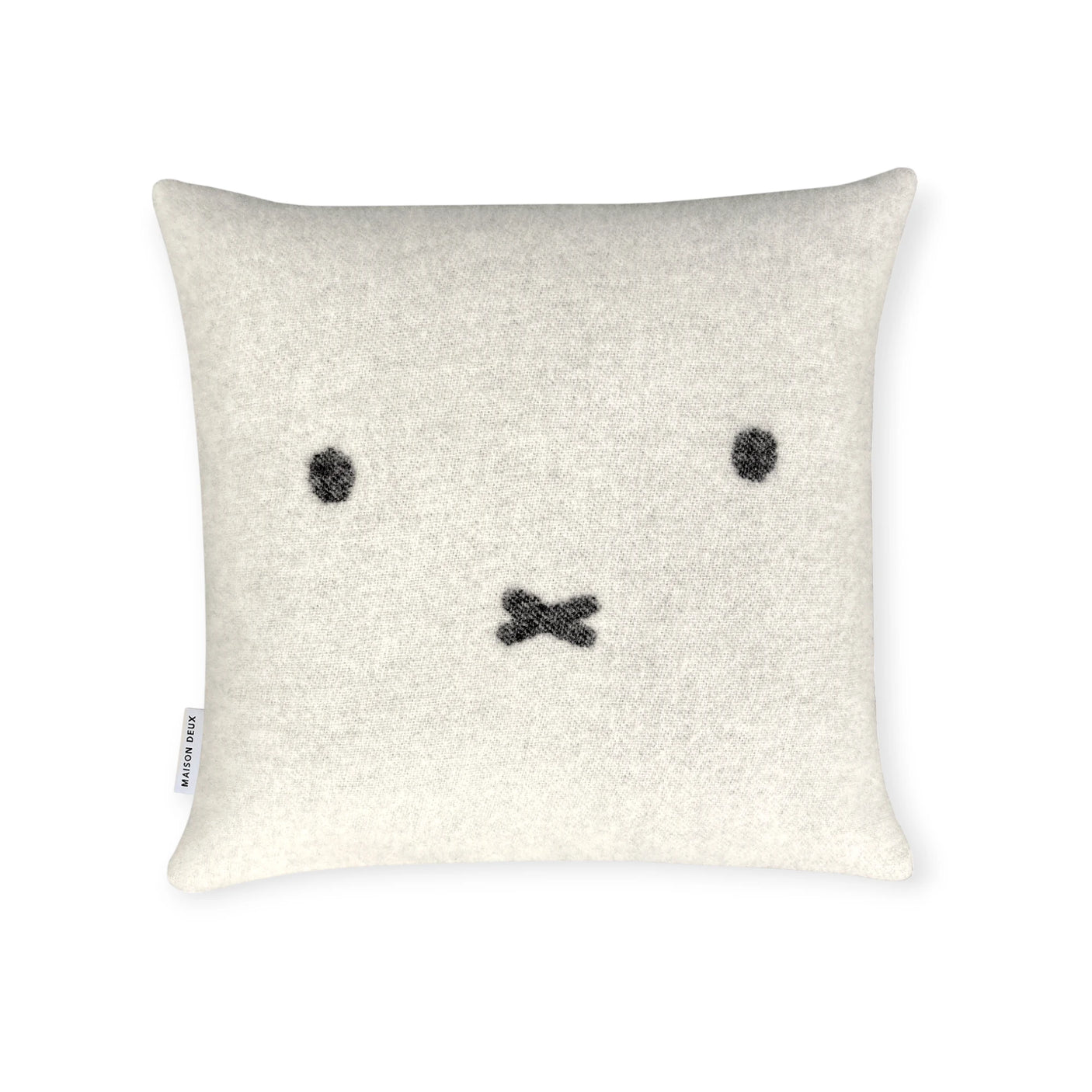 The Miffy Cushion Cover - Premium Wool by Miffy features a white square design with a simple black face (two eyes, X-shaped mouth) on cozy, sustainable premium wool. Shown on a plain white background.