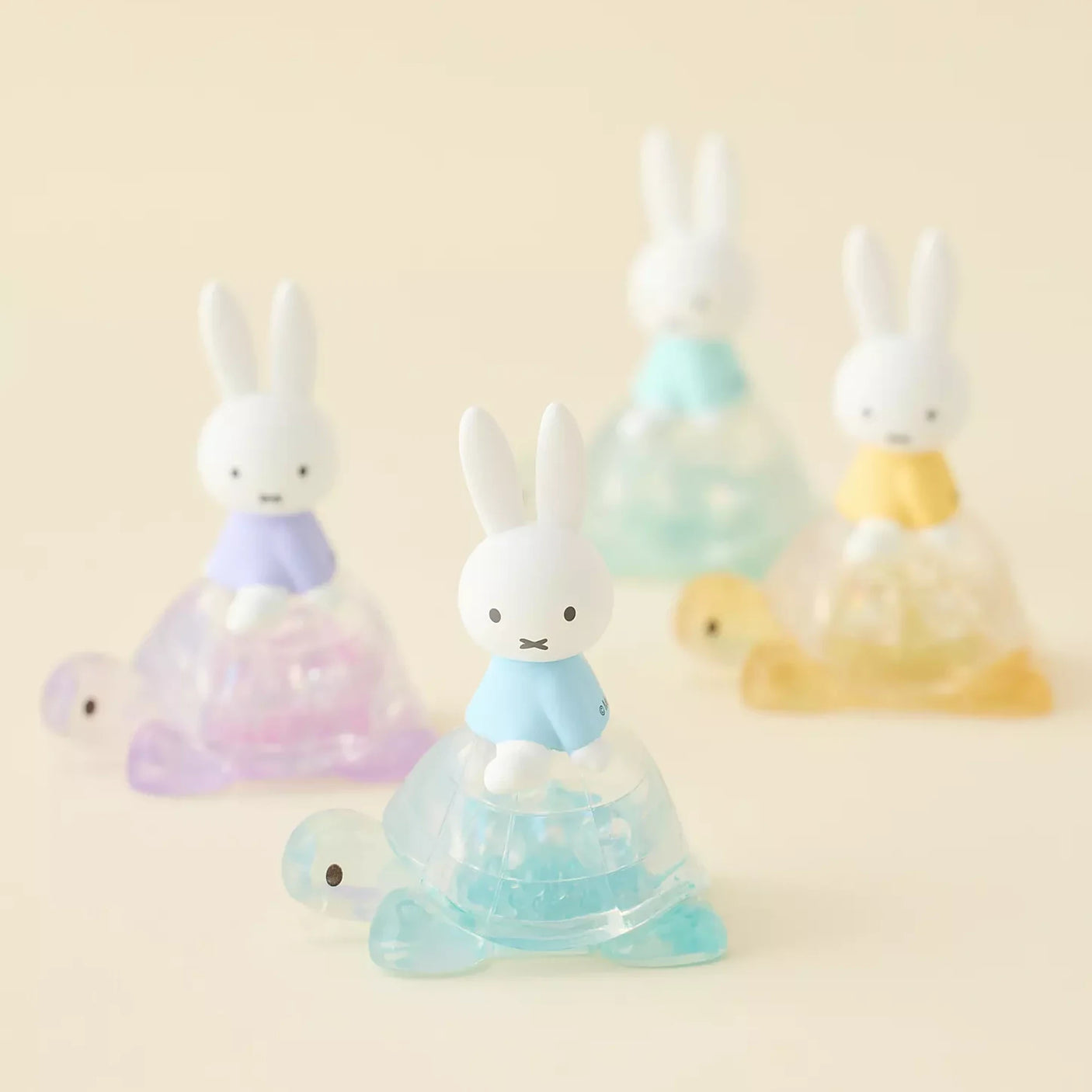 Rabbit blind box figure in translucent light-blue and pink cone dress
