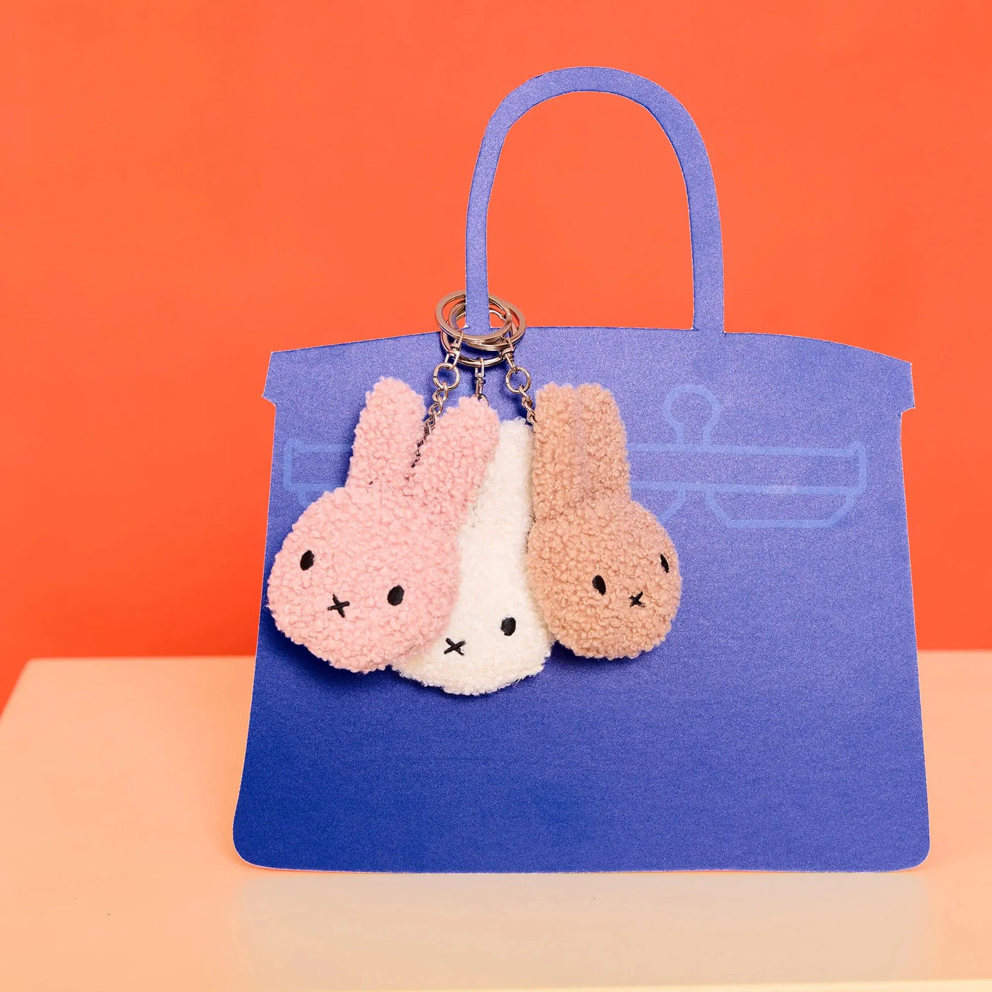 Beige and white terry plush bunny keychains with metal rings