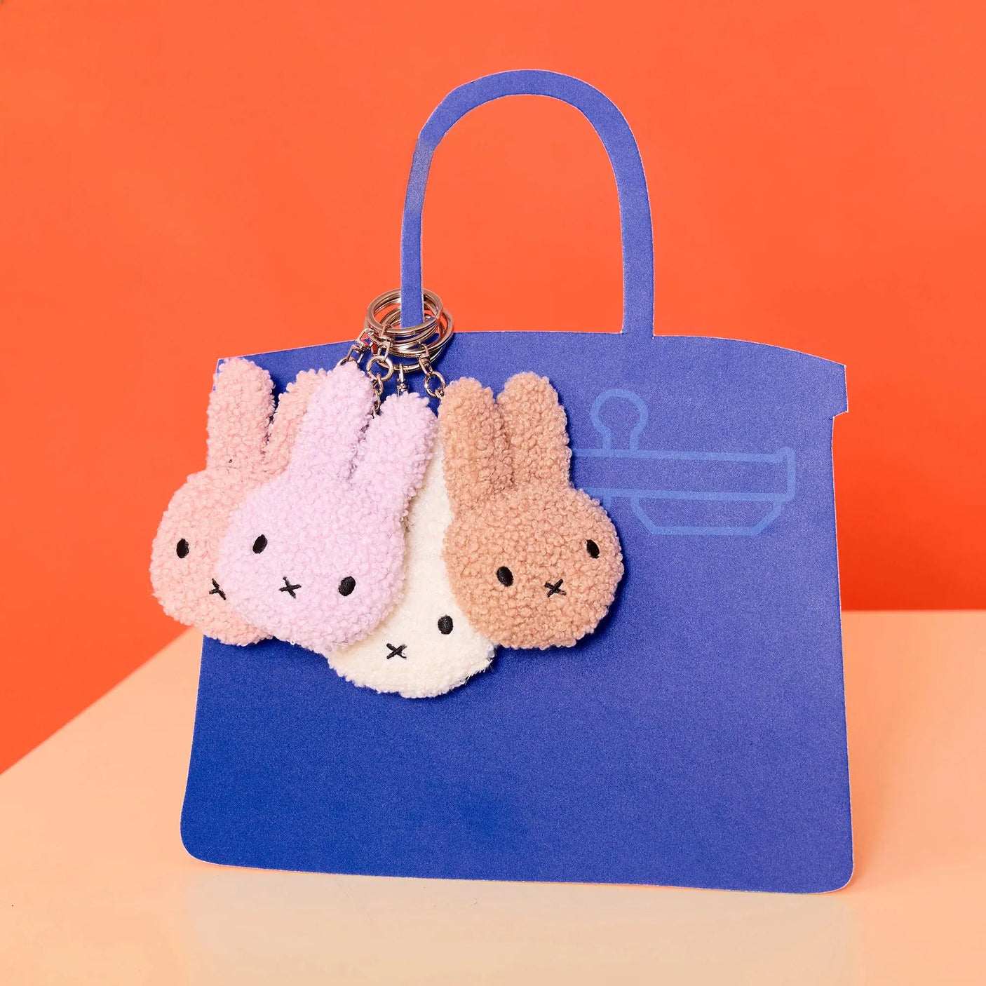 Lavender Miffy terry plush keychain with two bunny faces and metal key ring