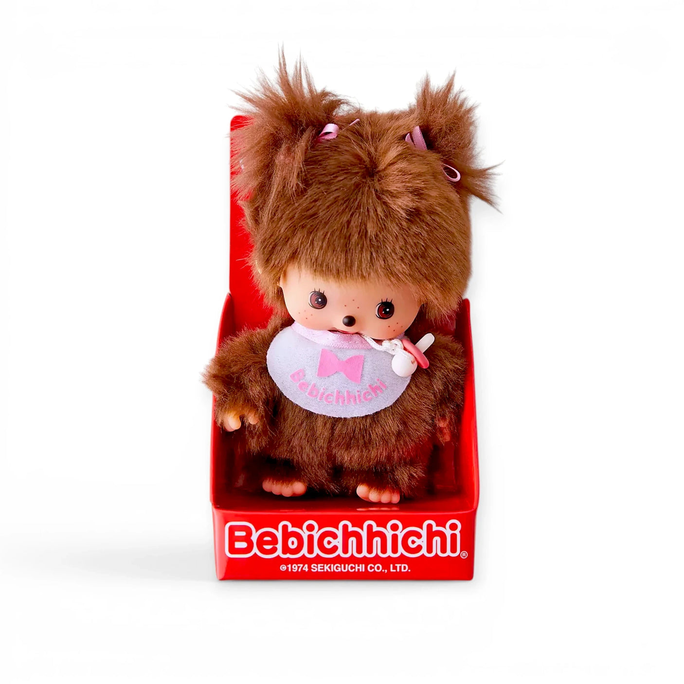 Brown plush doll with soft hat and white bib with pink bow