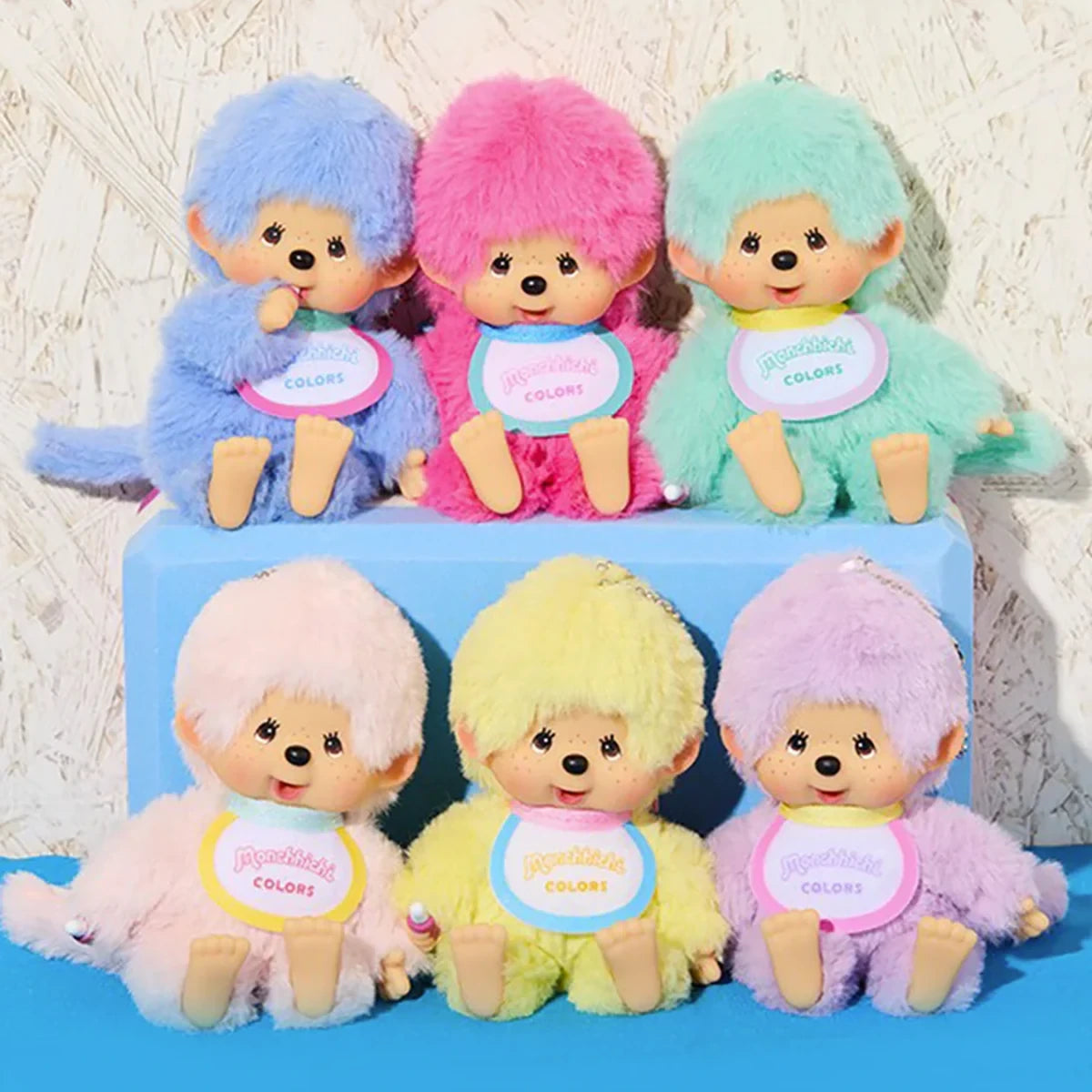 The Monchhichi Colours Bag Charm in Mint Green by Monchhichi features a plush monkey doll, ideal as a stylish bag charm or unique keychain gift. Perfect for adding cute flair to your accessories.