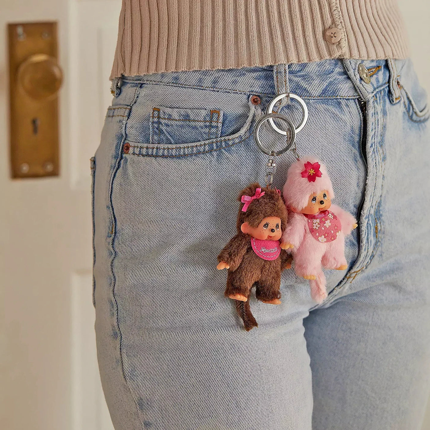 Keychain charms attached to denim jeans with plush girl figures