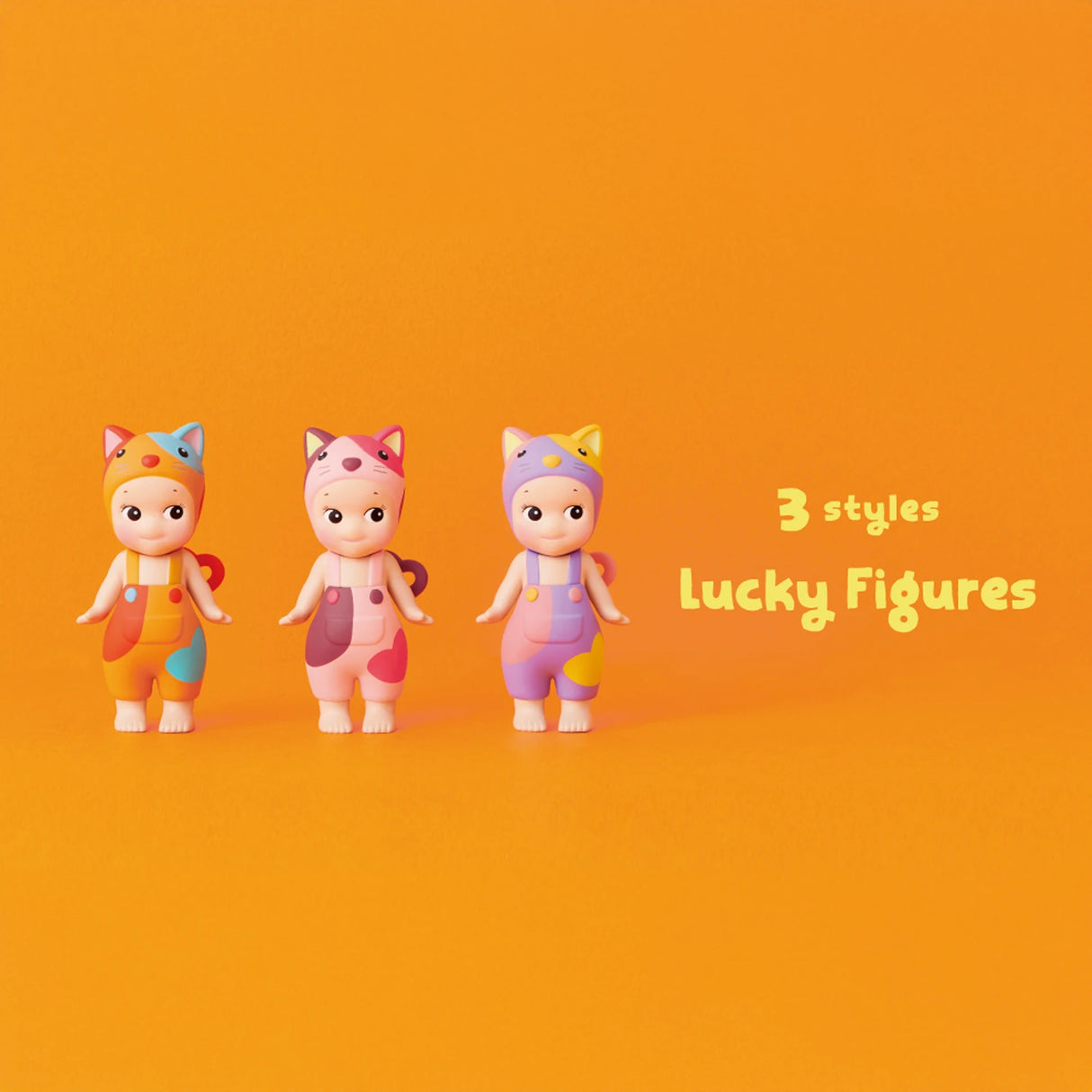 Three vibrant toy figures wearing cat-ear hats are arranged against an orange backdrop. Text reads "3 styles Lucky Figures" from the Sonny Angel Cat Life Series, showcasing limited edition designs.