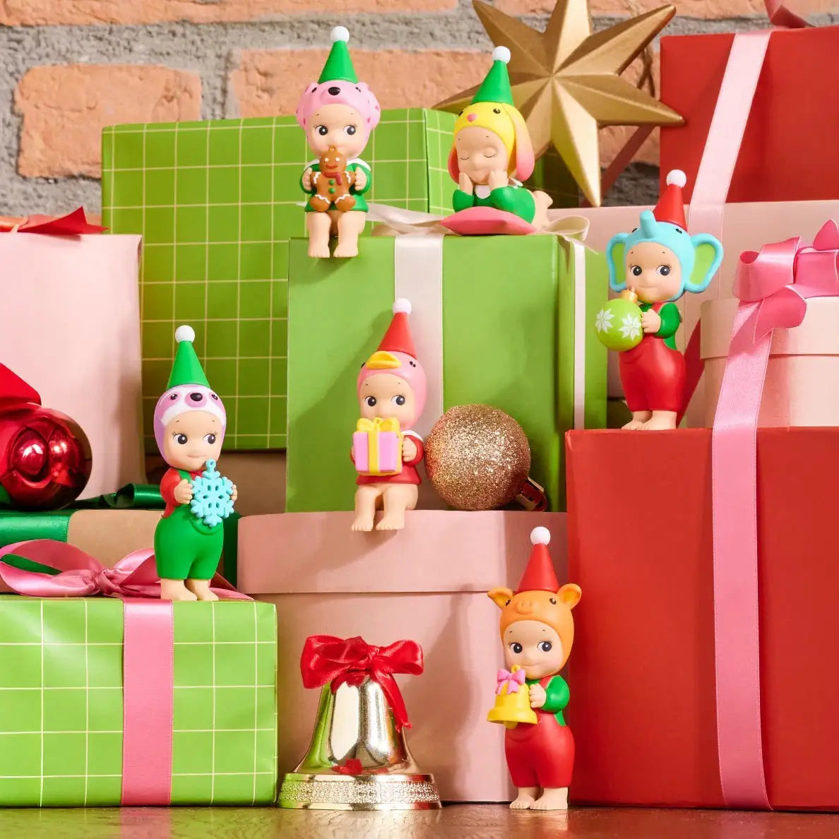 Assorted mini elf vinyl figures posed on colorful stacked gift boxes