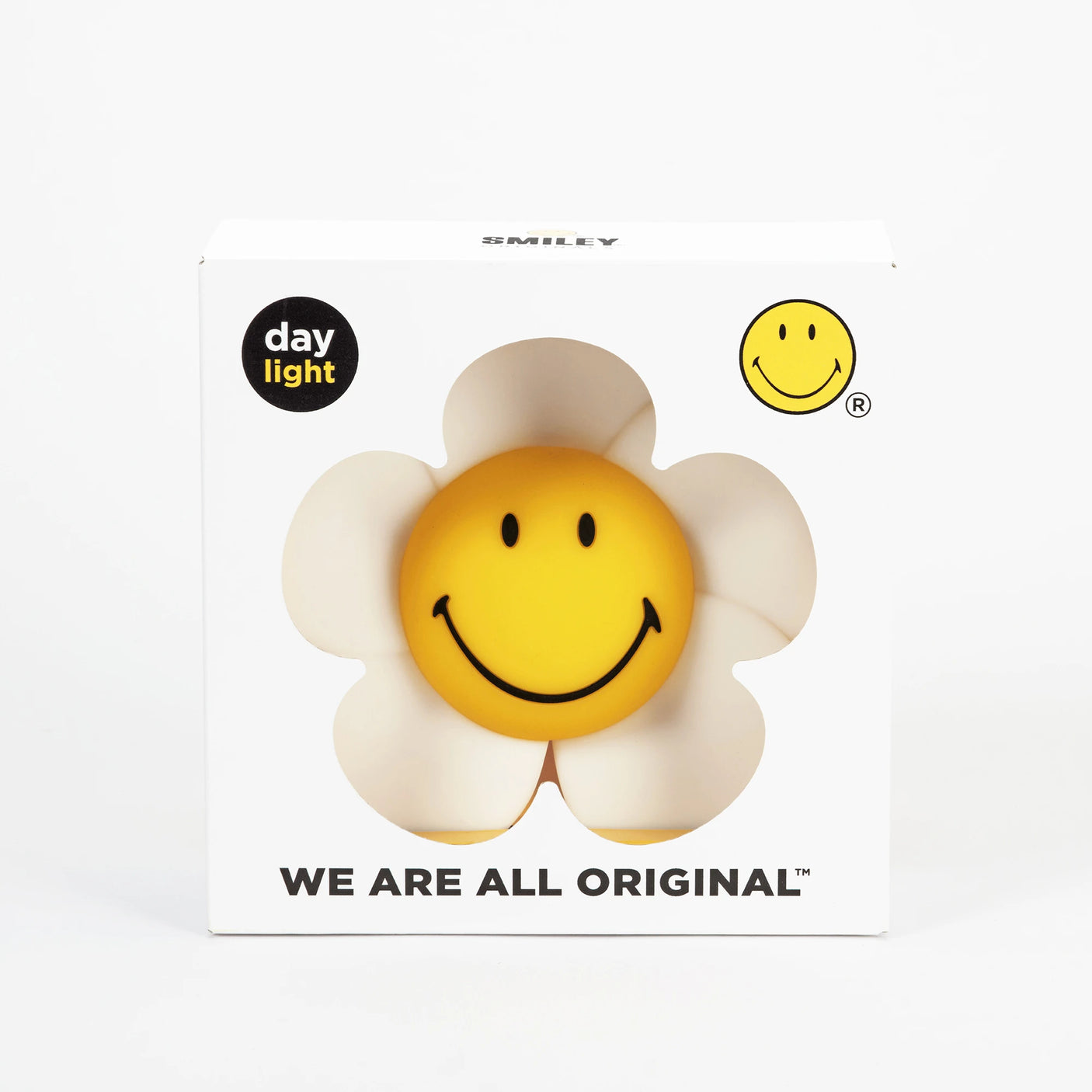 The Mr Maria Smiley Daisy - Day & Night Light is a yellow daisy-shaped face ball in a white retro flower power box, featuring "WE ARE ALL ORIGINAL" printed at the bottom.