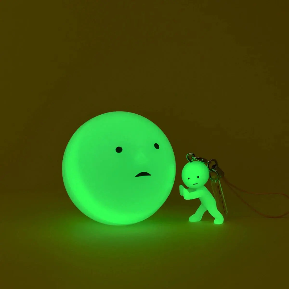 Smiski glow green strap keychain charm with miniature figure and lanyard