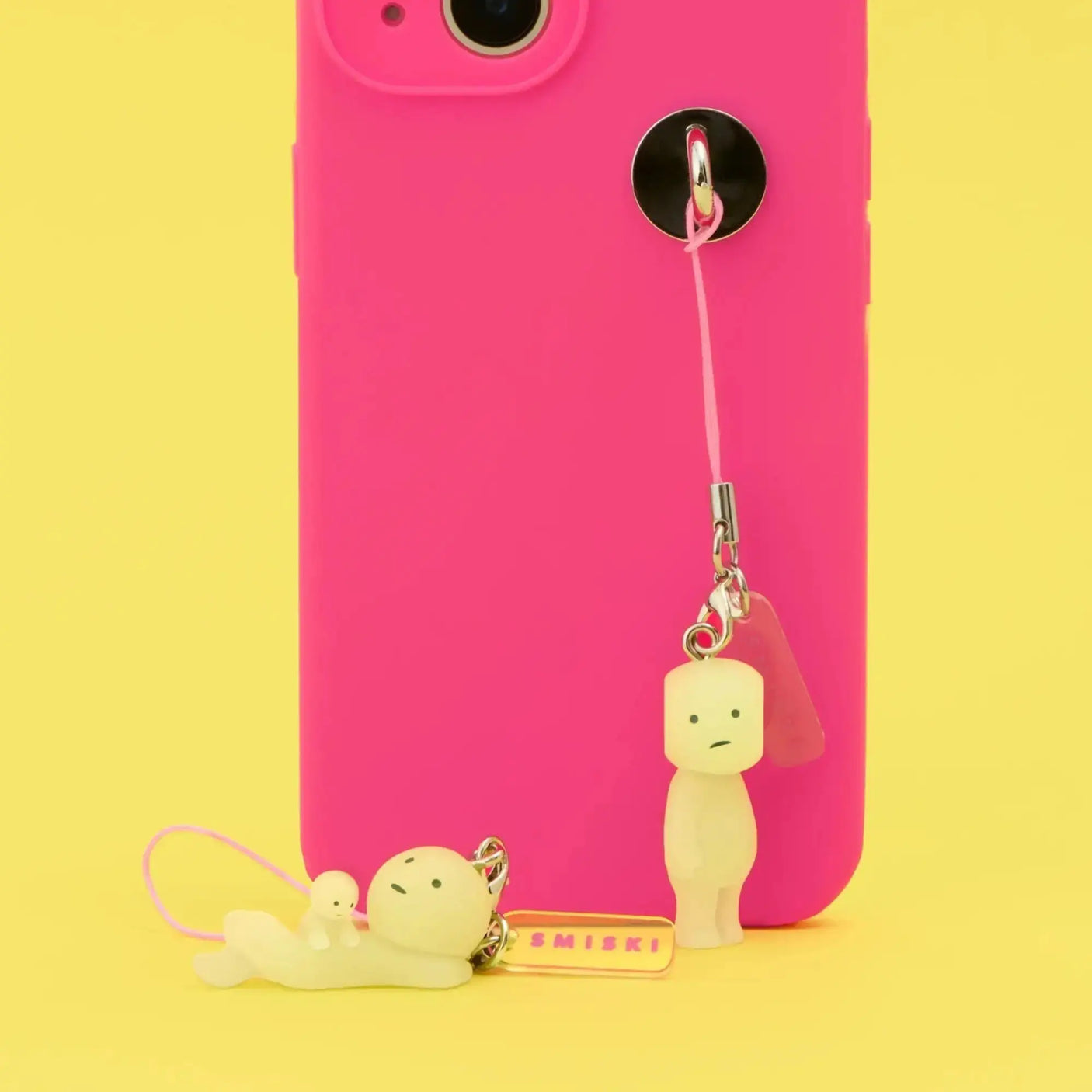 Smiski strap keychain with pink cords, metal rings, and small yellow character charms