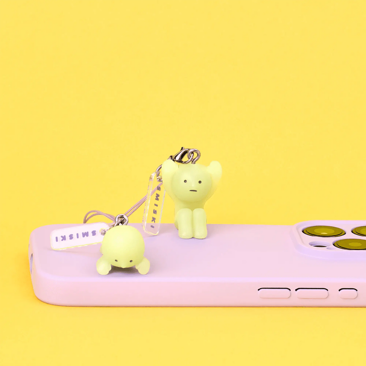 Lime green smiski strap keychain figurine with metal clasp and light purple tag