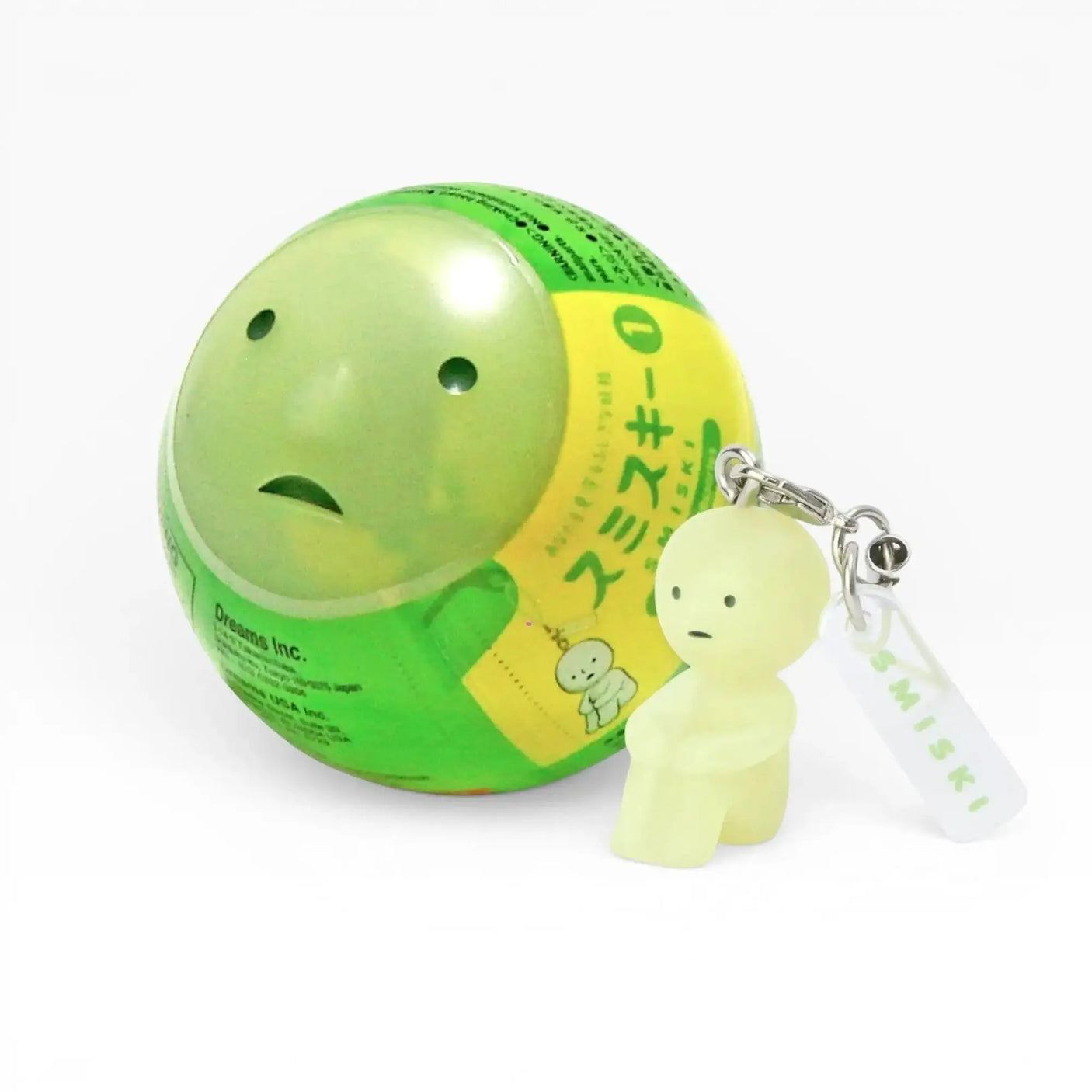 Smiski-style figure keychain attached to a green ball charm
