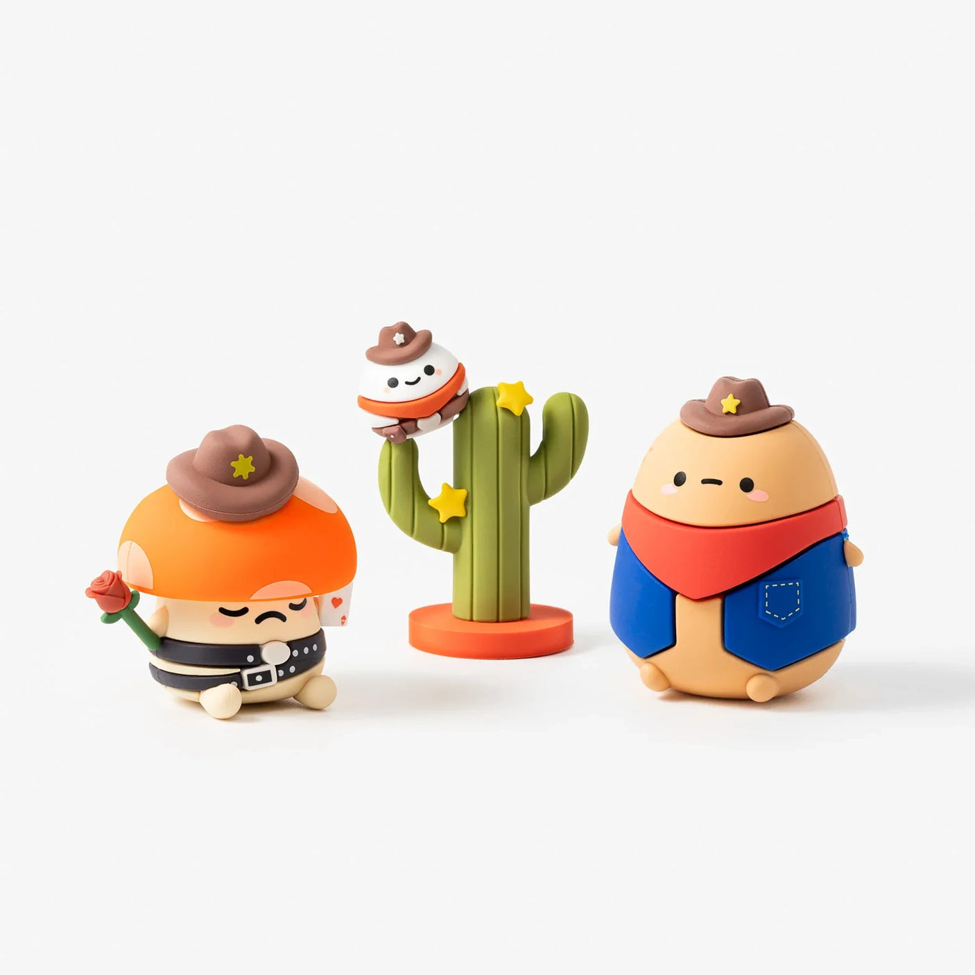 Three Wild West blind box figures: cactus bandit, a cowboy, and a bear in overalls