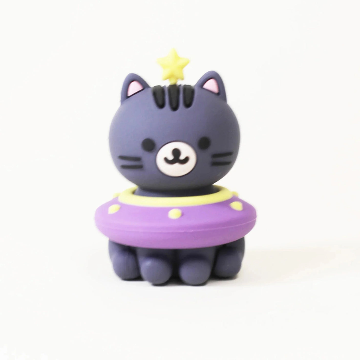 A Smoko Astrocats Blind Box figure by Smoko features a black cat with a yellow star on its head and a purple-and-yellow UFO ring, glowing in the dark against a plain white background.