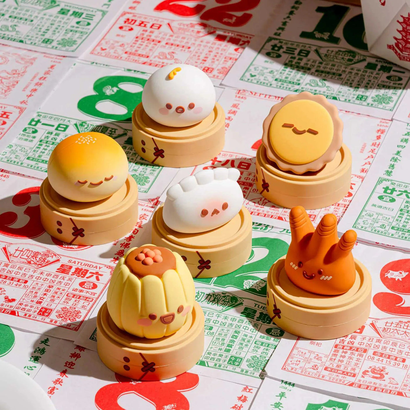Stacked dim sum blind box figurines with smiling faces on round tan bases