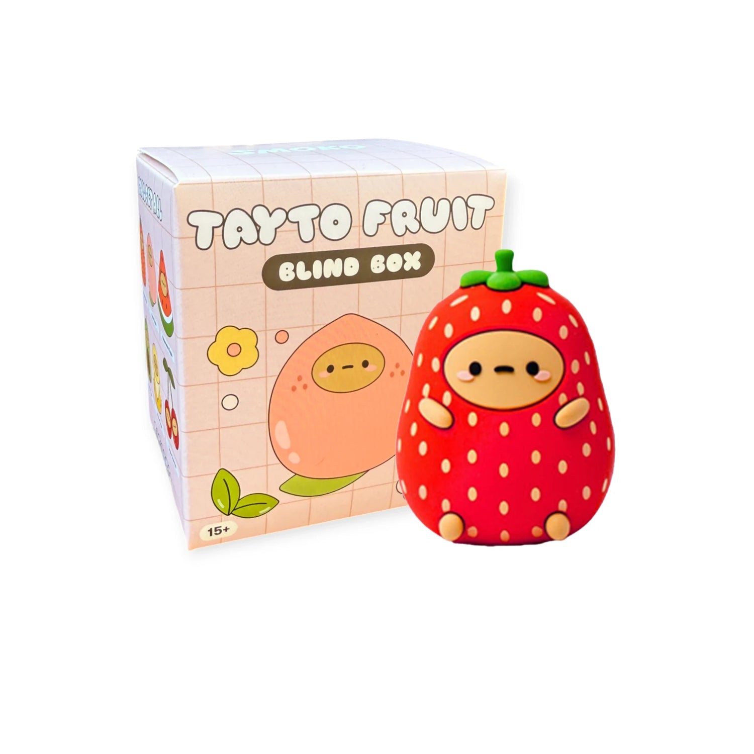A red strawberry-shaped vinyl figure with a cute face stands beside Smoko Tayto Fruit Blind Box packaging from Smoko.