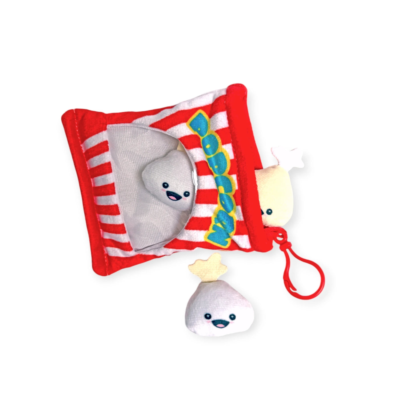 The Snack Bites Bag Charm by Bensons is a plush toy set that looks like a popcorn bag and includes two smiling popcorn pieces. One piece is outside the bag with a red clip for easy attachment, adding playful snack style to any collection.
