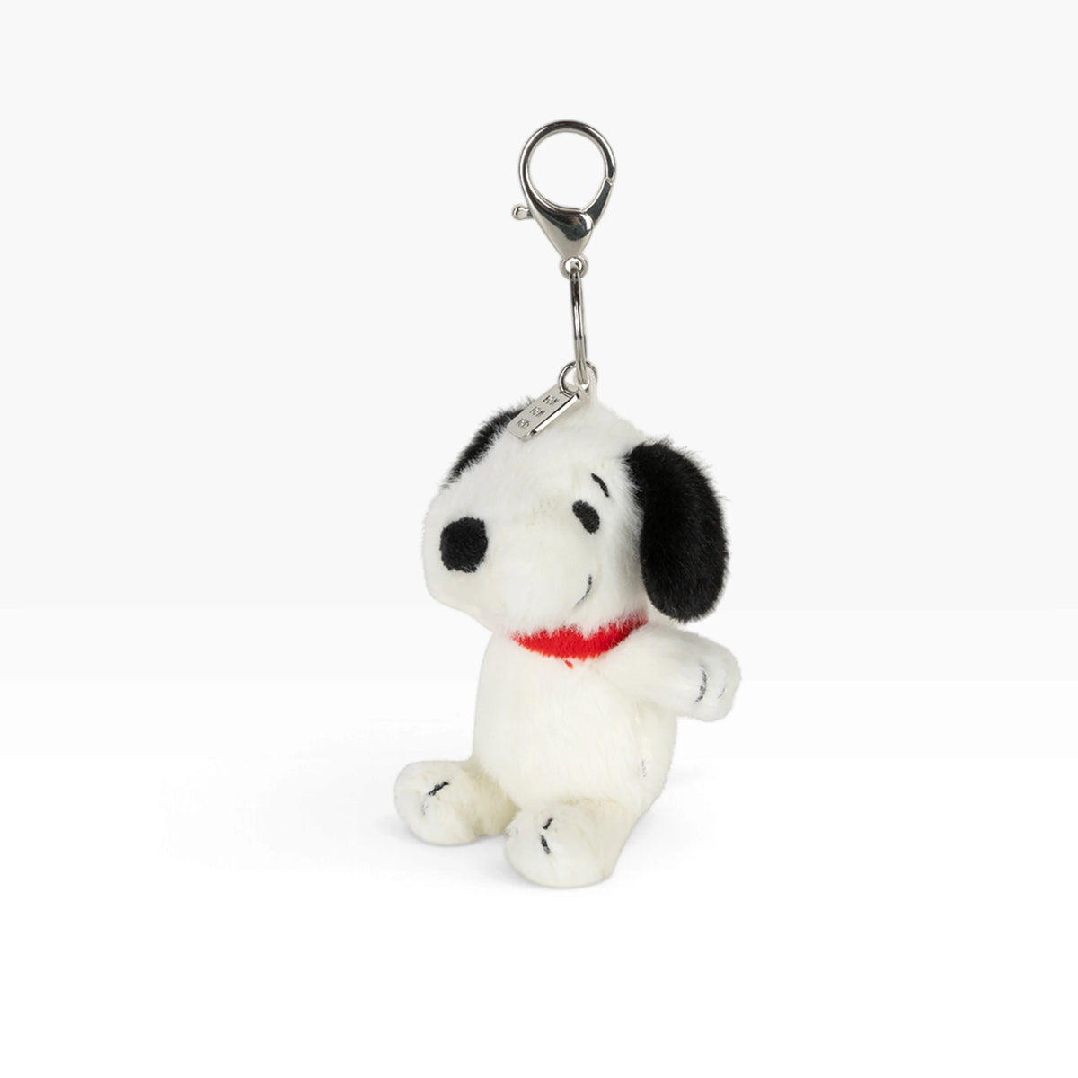 Fuzzy Snoopy keychain with metal clip and ring, side sitting plush dog