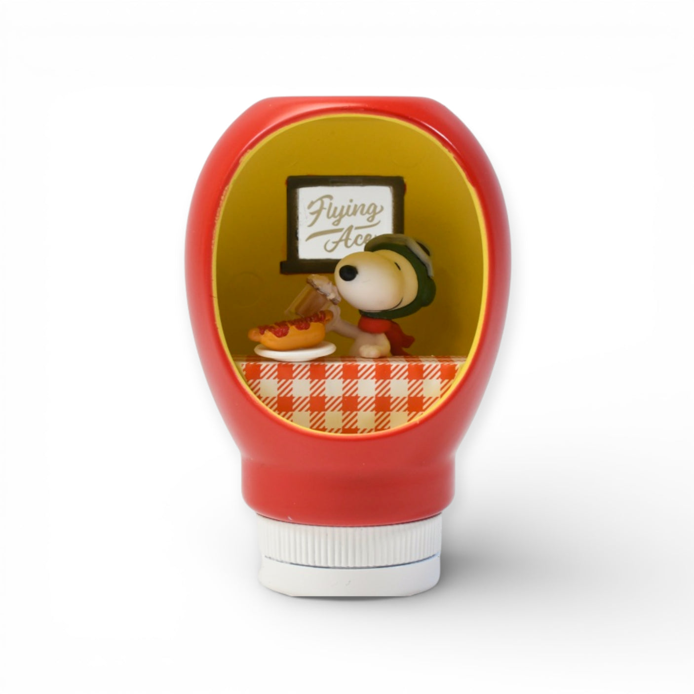 Red sauce bottle figurine featuring Snoopy as Flying Ace with pilot helmet and scarf inside a cozy diner scene
