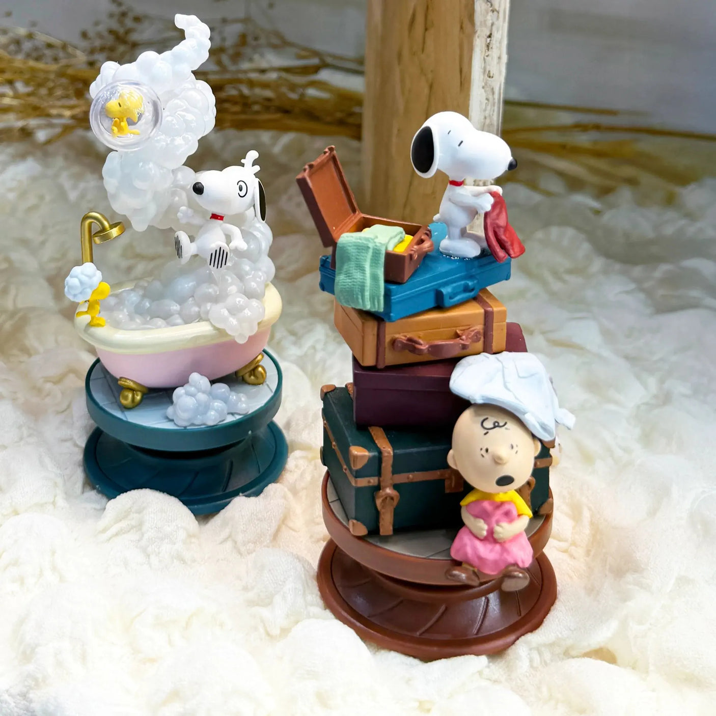 Snoopy spiral diorama figures on bases: white cloud scene and brown crate scene