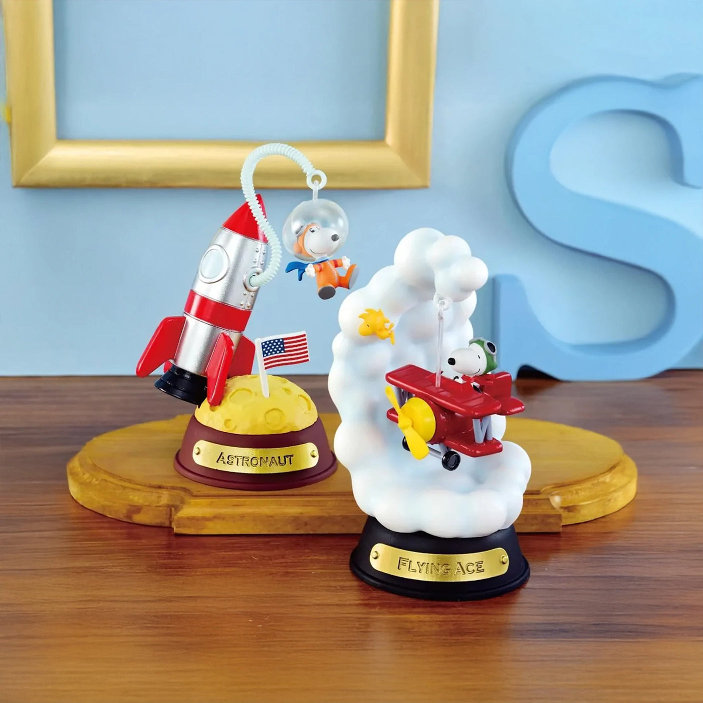 Snoopy astronaut with rocket and Woodstock flying plane through cloud smoke on display stands