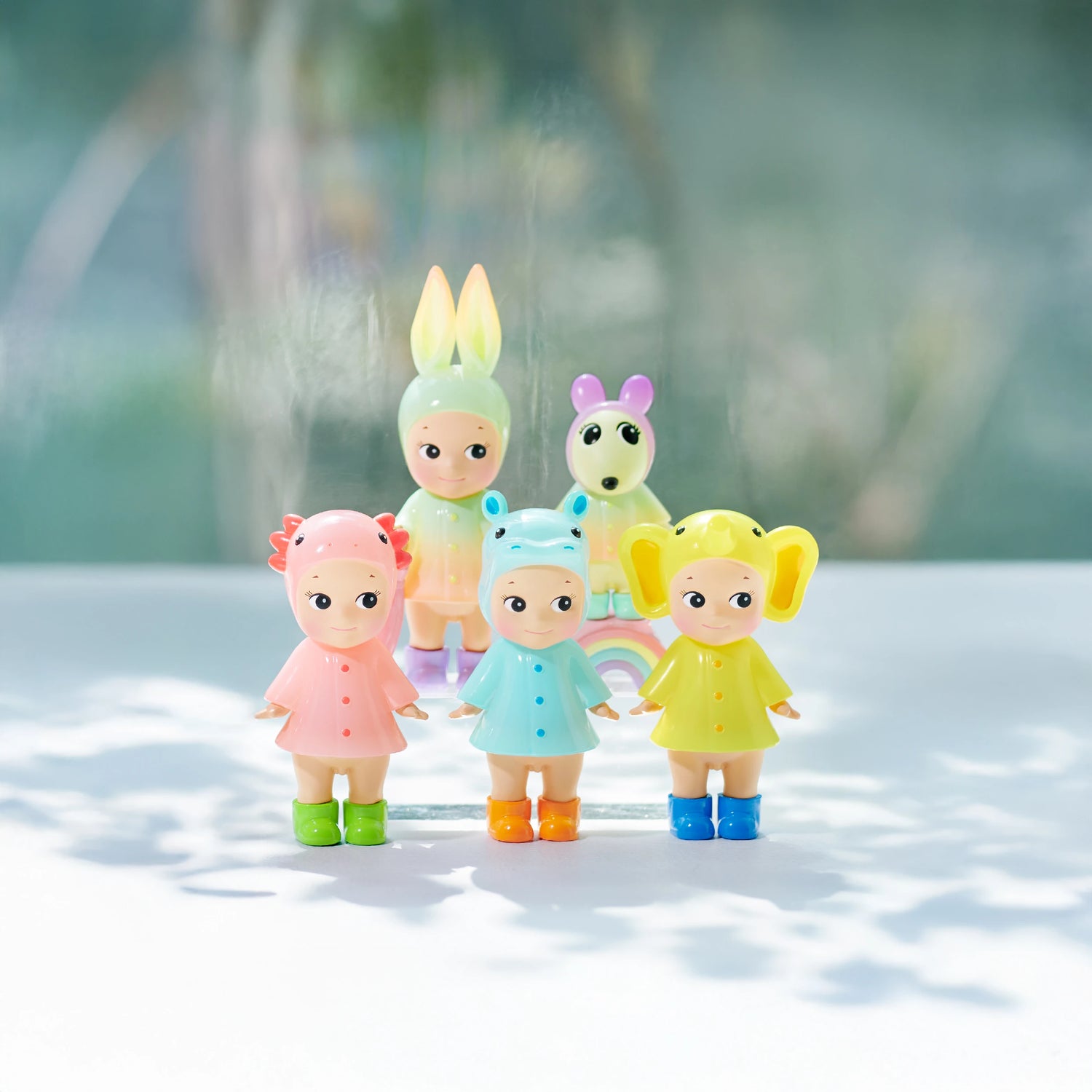 Five Sonny Angel Rainy Day Blind Box Limited Edition figurines from Sonny Angel, each in animal-themed costumes, stand on a white surface with a blurred natural background.