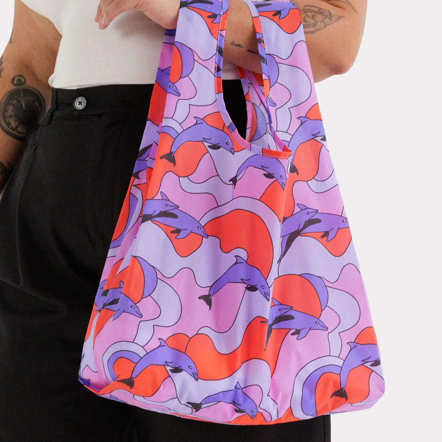 Standard Baggu bag with purple and coral dolphin print, carried by top handles