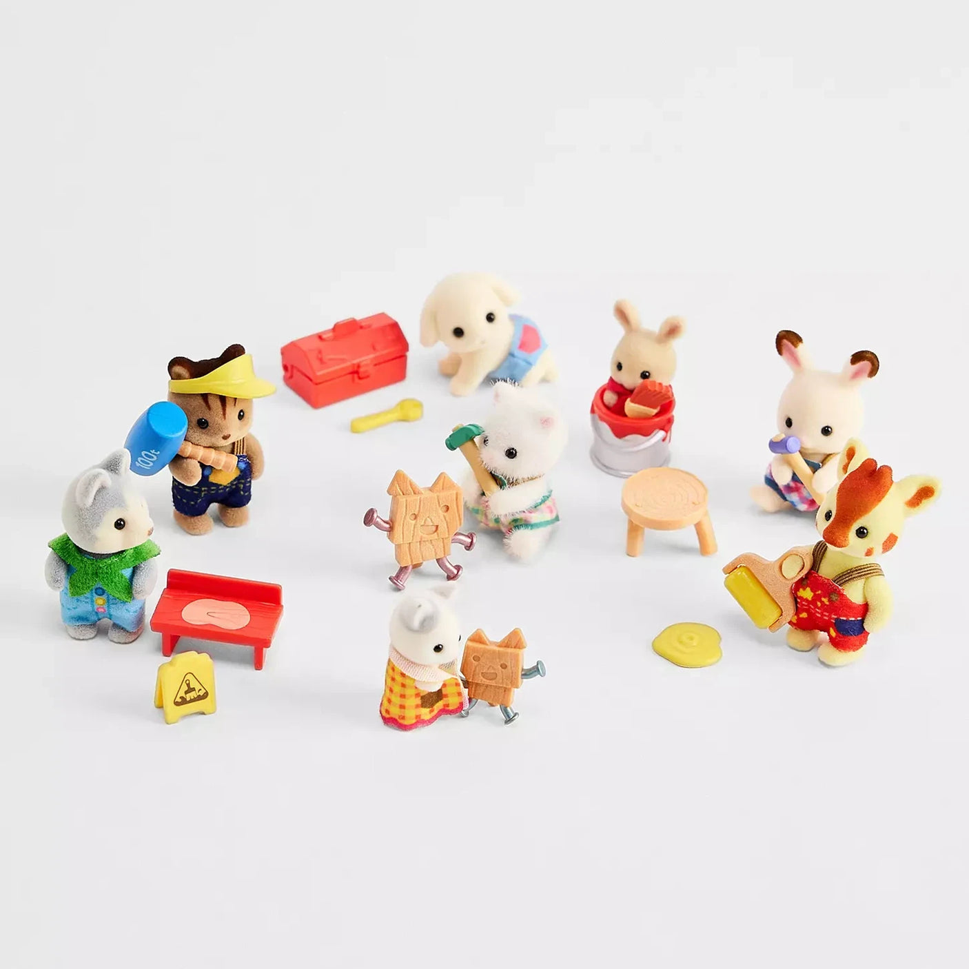Sylvanian Families Blind Bag - Baby Builder collectible animal figurines by Sylvanian Families are dressed as builders, posed with tiny workshop tools, on a white background.
