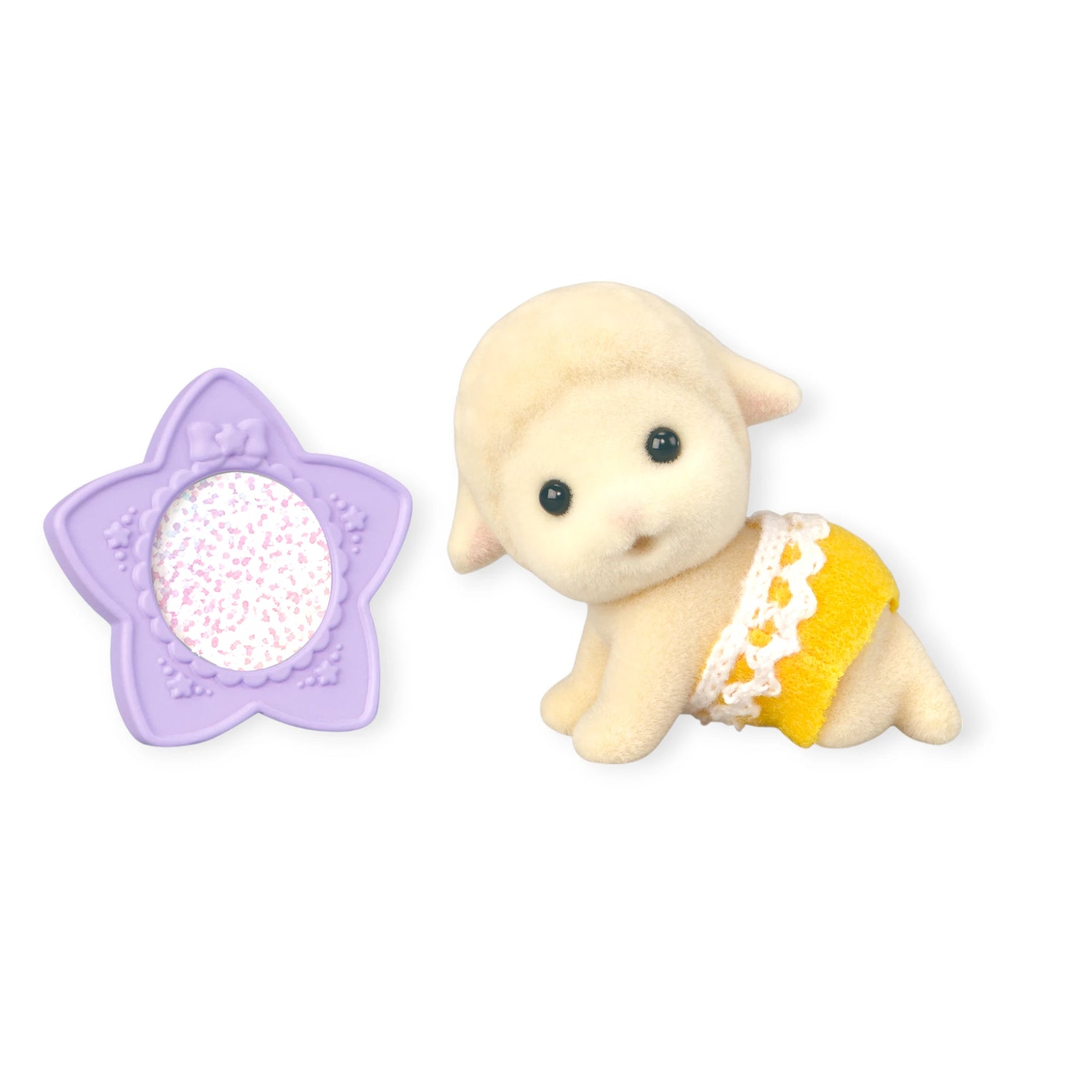 A Sylvanian Families Blind Bag - Baby Fun Hair lamb toy in a yellow diaper sits beside a purple, star-shaped hair accessory with white speckles.