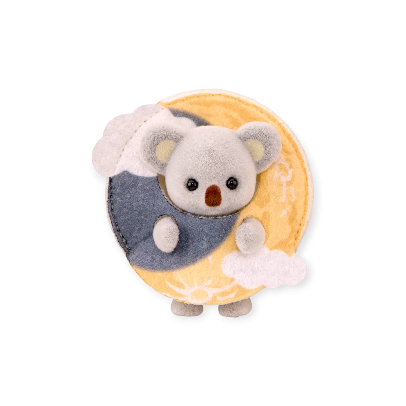 Gray koala figurine nestled in tan crescent moon pouch
